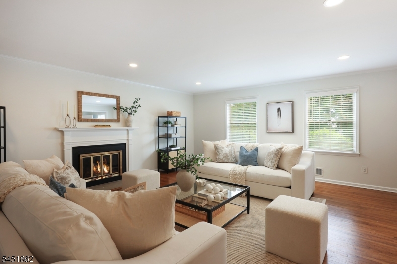 Completely renovated in 2021/2022, this spacious 2-bedroom, 2.1-bath end unit offers beautifully updated living space in an intimate five-unit complex. The inviting living room features a gas fireplace and flows seamlessly into the dining room, creating an ideal setting for everyday living and entertaining. The eat-in kitchen boasts stainless steel appliances, crisp white cabinetry, stone countertops, and access to the rear deck. The primary suite is a private retreat featuring a dressing area, walk-in closet, and beautifully appointed bath with marble shower and flooring, plus quartz countertops. A generously sized second bedroom offers ample closet space, while a full hall bath, powder room, and convenient laundry area complete the main living level. With windows on all sides, this desirable end unit enjoys abundant natural light and exceptional storage, including two lower-level storage rooms. A two-car garage and dumbwaiter providing convenient access to the unit add to the appeal. Best of all, the location is unbeatable just moments from vibrant downtown Westfield's shops and restaurants, the commuter train station, and top-rated schools. A rare combination of space, style, convenience, and location!