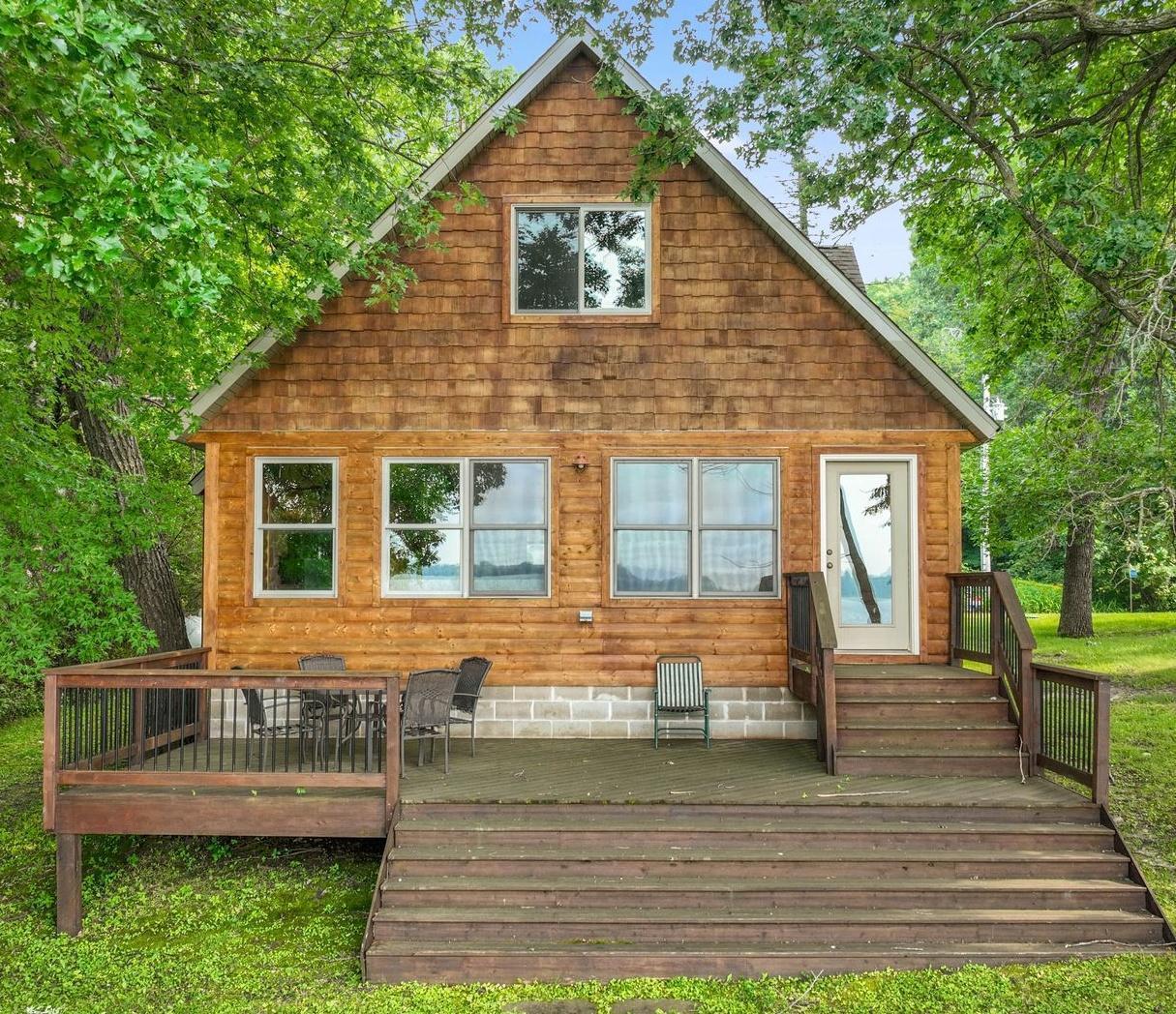 Very nice, year round home. Large ceramic tile foyer , which also serves as the laundry room. The 3/4 bath is just around the corner from the foyer. Beautiful cabinetry and wood floors throughout the kitchen and dining area. Large living room offers gorgeous west facing lake views. The beautiful stone fireplace and the 1/2 log walls and tongue and groove ceiling really present that "cabin feel". The upper level includes a large bunk room area (listed as 2nd bedroom) that could be a game room, amusement room or a combination of all. There is a large bedroom and full bath with jetted tub here on the upper level. Across the private dead end road is a 30x35 garage. The lake front is very nice hard sand bottom. Lake Ida is a very clean, good fishing and recreation lake. Very conveniently located just over a half an hour from the west Twin Cities Metro. This is a great lake property!!