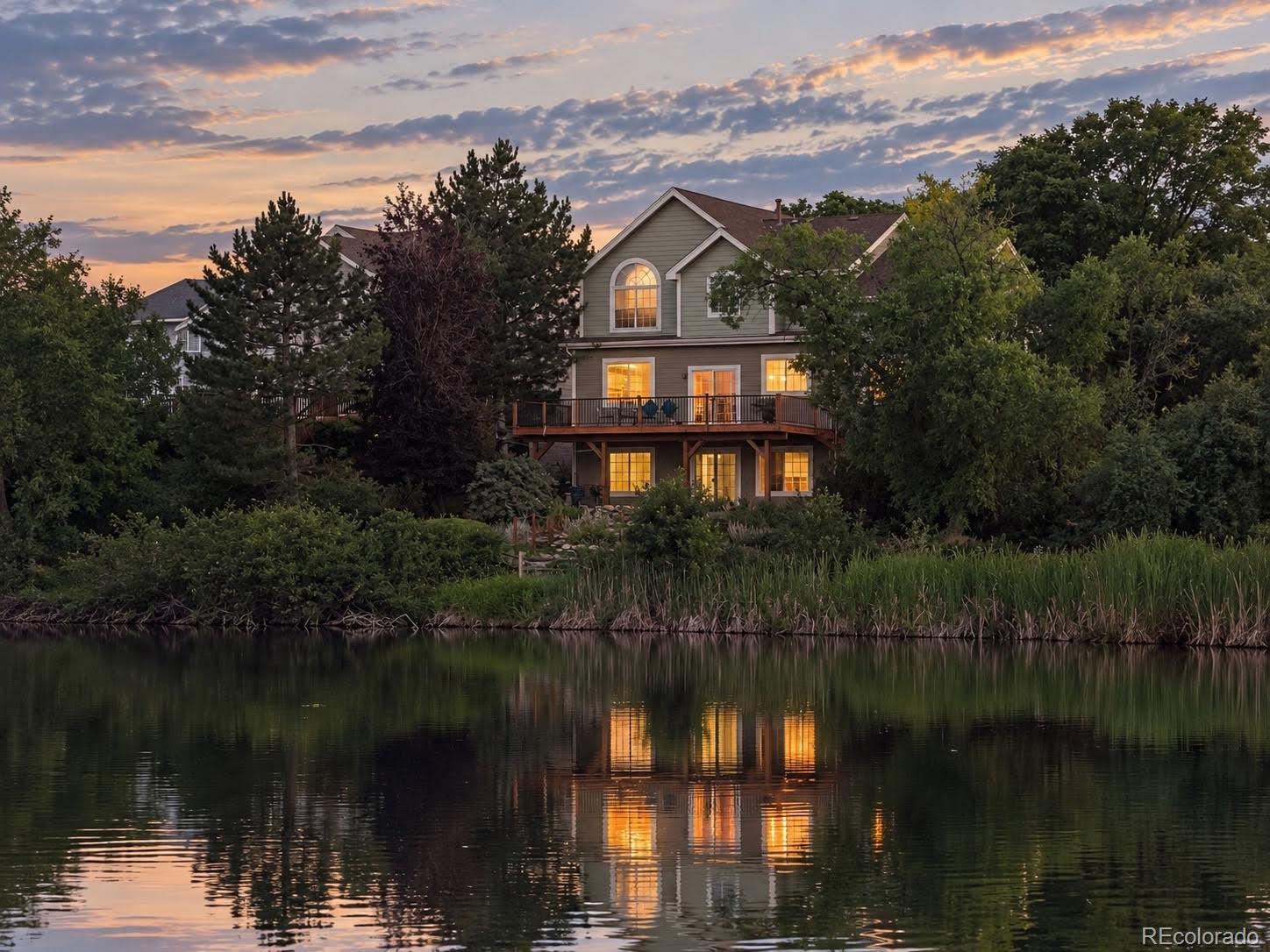 Spectacular and RARE lake views are the centerpiece of this spacious four-bedroom home in Lakewood’s desirable Three Lakes neighborhood. Enjoy the beautiful water backdrop from the family room, kitchen, dining room and primary suite, as well as from the expansive deck and walk-out lower level. The flexible main floor features a light-filled family room with a gas fireplace, kitchen with granite island and seating and a wet-bar/prep sink, and a bedroom or private home office conveniently located beside a three-quarter bathroom. Main-floor laundry and an attached three-car garage add everyday ease. Upstairs, the generous primary suite offers lovely lake views, a walk-in closet and a private bath with a soaking tub and separate walk-in shower. Two additional bedrooms, a full hall bathroom and a spacious landing or loft area complete the upper level. The walk-out basement provides additional recreation and entertaining space with a second wet bar, while a substantial unfinished area offers excellent storage, hobby space or future possibilities. Step outside to the lower patio or relax on the large upper deck and take in the peaceful lake setting and surrounding landscape. Recent improvements include brand-new carpeting throughout in August 2026 and a new furnace installed in 2024. With its exceptional water views, versatile layout, walk-out basement with room to expand livable space and three-car garage, this inviting home offers a rare opportunity to enjoy the beauty and tranquility of lakeside living in an urban atmosphere.