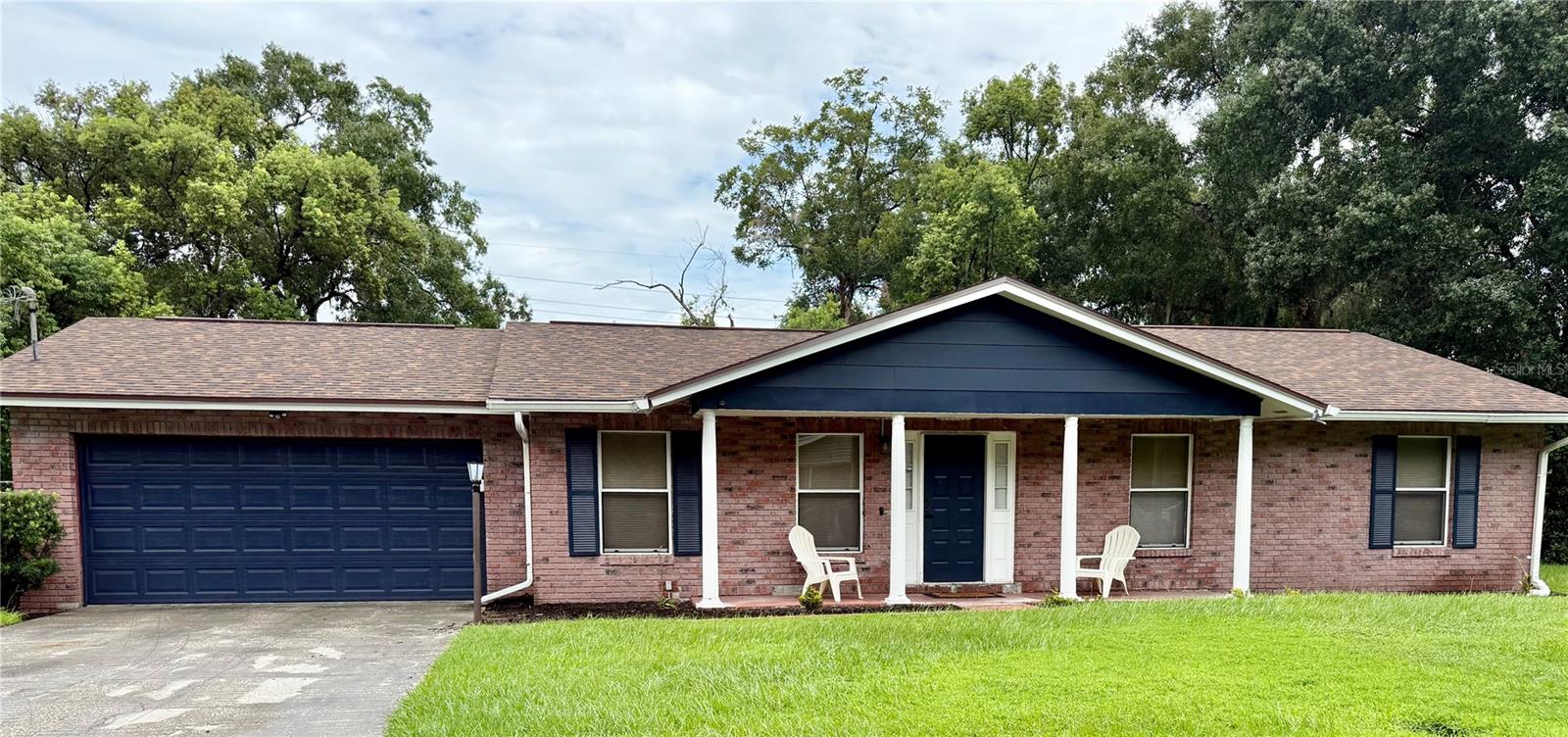 Pictures coming soon! This meticulously maintained Plant City brick ranch has all the big-ticket items already taken care of: new roof (2026), new electrical (2026), new irrigation system (2026), water heater (May 2026), and AC replaced in 2024. Move in with total peace of mind!Nestled on a lush, tree-lined lot, this charming 3-bedroom home welcomes you with navy blue accents, a covered front porch, and mature oak canopy. Inside, an updated kitchen features stainless steel appliances, wood cabinetry, and a breakfast bar, while the family room's cozy stone fireplace and a separate living room offers plenty of space to relax or entertain. Both bathrooms have been tastefully updated, including a beautifully tiled walk-in shower. Step outside to your screened-in POOL and lanai, perfect for Florida living. The oversized two-car garage includes a fully renovated laundry setup, epoxy-coated floor, and outdoor cameras for added peace of mind. Tucked in a quiet neighborhood with easy access to I-4 and quick connections to Tampa and Lakeland — schedule your private showing today!
