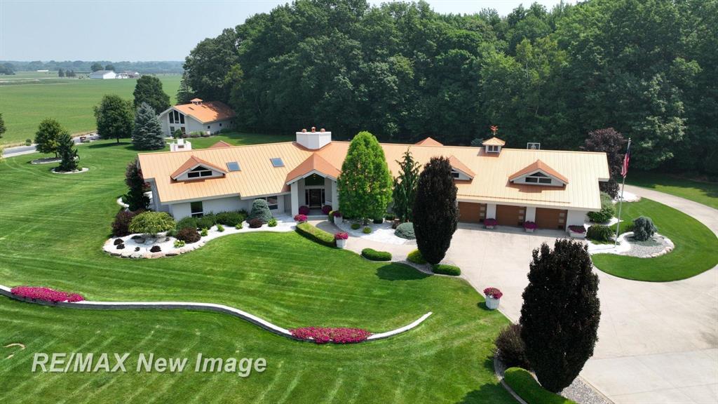 Welcome to one of the most impressive and immaculate luxury homes in all of Saginaw County. Nestled on 5 private acres in sought-after Thomas Township, this custom all-brick estate offers 5,108 square feet of exceptional design, craftsmanship, and elegance. A sprawling split ranch layout and immense architectural details are complemented by soaring vaulted ceilings and expansive windows that flood the home with natural light.  The stunning primary suite is a true retreat, featuring its own fireplace, a huge walk-in closet, jet tub, and a spacious walk-in shower. The home includes a sunken living room with fireplace, a family room complete with built-in bar, a bright sunroom with in-floor heating and its own additional bar, and a large office/den/workout room to suit your lifestyle. The main floor laundry adds convenience, while two bonus rooms upstairs provide flexible living space for guests, hobbies, or storage.  New boiler plus 2 gas forced air furnace and AC units.  Newer garage doors. The possibility for a 4th or even 5th bedroom is there.  At the heart of the home is a well-appointed kitchen with stainless steel appliances, perfect for entertaining or everyday living. Step outside to a massive wraparound patio with a built-in bar and grill-ideal for hosting unforgettable parties or relaxing family gatherings. Every detail of the property has been thoughtfully planned, including a heated, drive-thru 5-car attached garage with ceramic floors and a matching 60x40 all-brick detached 6 car garage featuring a small kitchen, half bath, and finished living or bonus space. Beautifully landscaped and meticulously maintained, this one-of-a-kind gem offers the perfect blend of luxury, privacy, and function. With a newer steel roof and skylights, 3.5 bathrooms (5 toilets), and unmatched attention to detail throughout, this is a rare opportunity to own a true estate in one of the area's most desirable locations.