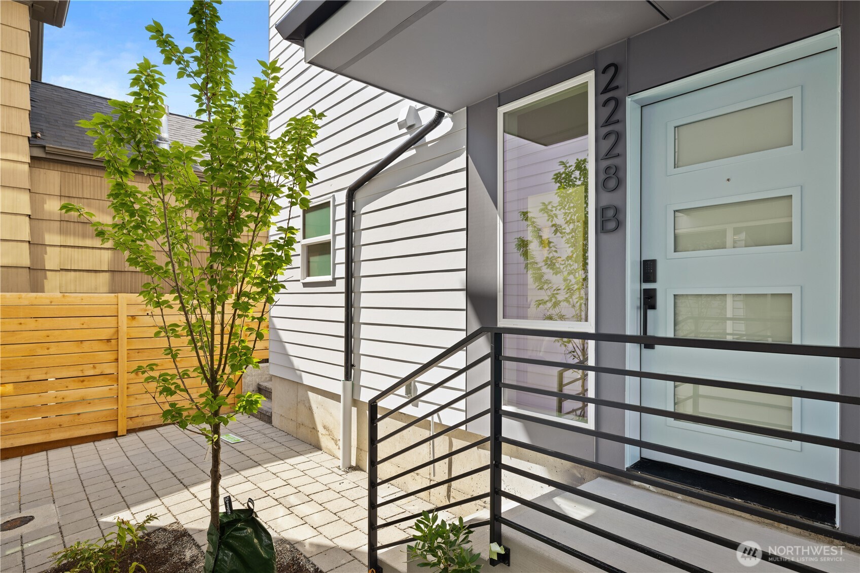 1% lender credit through preferred lender—ask for details! Welcome to Vela, a rare new construction opportunity in the heart of Ballard. Discover elevated living in this boutique collection by premier builder MRN Homes. This beautifully curated corner residence pairs abundant natural light, lush green outlooks and refined design with EV-READY PARKING INCLUDED w/EV charging capability. Walls of windows illuminate the open-concept main level, anchored by a chef-inspired kitchen with oversized island, quartz counters, custom cabinetry and designer finishes. The spacious primary suite offers a walk-in closet and spa-inspired bath, while the versatile secondary bedroom is ideal for guests or a home office. Enjoy sweeping territorial and Olympic Mountain views from the expansive rooftop deck providing indoor-outdoor living with room to relax and entertain. Unbeatable Ballard location near top cafés, shops, dining, nightlife, Ballard Market, Burke-Gilman Trail, Golden Gardens and the waterfront. No HOA dues. Sophisticated design, exceptional outdoor living, and the best of Ballard right outside your door.