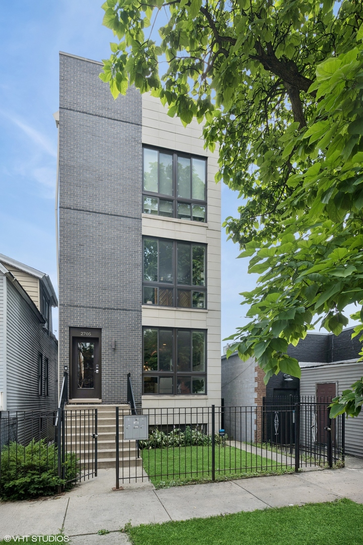 Welcome to this stunning duplex down in Logan Square! From the moment you step inside, you'll feel the care and attention to detail that makes this home truly special. The expansive main level features a sun-drenched front living room, a dedicated dining area, and a designer kitchen outfitted with premium Bosch appliances, two-tone cabinetry, quartz countertops, and subway tile backsplash. The kitchen flows seamlessly into a spacious family room, which opens directly onto a private deck. Downstairs, all three bedrooms are thoughtfully situated on one level for optimal comfort and convenience. The luxurious primary suite offers an en-suite bathroom with a walk-in rain shower, double quartz vanity, and heated floors. The custom walk-in closet, now built out with high-end Elfa closet treatments, provides both style and function. In fact, all three bedroom closets have been newly customized with Elfa systems to maximize organization. Additional features include brand new custom window treatments in every single room in the condo, in-unit laundry, and a private lower-level patio--now enhanced with brand new deck tiles. The home also comes with a covered carport parking space and access to a shared backyard. Located steps from Logan Square's top restaurants, cafes, parks, and the Blue Line, this home offers the perfect blend of luxury, warmth, and urban convenience.