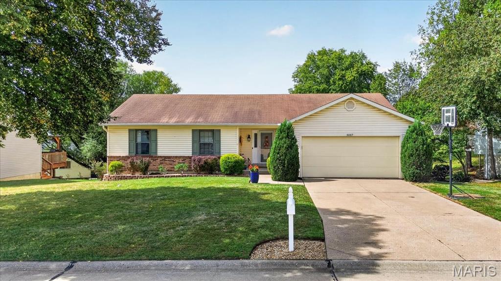 What a find! Beautifully updated 3 BDR, 3 FULL bath ranch with a finished walkout basement and oversized heated garage in a prime location. Within walking distance to Henderson Elementary, Francis Howell North HS and Laurel Park. Lovely curb appeal with updated landscaping, level yard, and a maintenance free vinyl exterior, including Gutter Helmets.  Warm and inviting  living room with gas fireplace and vaulted ceiling flows into the updated kitchen with white cabinets.  Updates include luxury vinyl plank, stainless appliances, tile backsplash and quartz counter tops.  Refrigerator is a year old and stays with home. Just off the kitchen is the extended dining area with vaulted ceiling, a window surround that creates a bright atmosphere, plus french doors leading to the deck.  Primary suite includes a large walk-in closet, plus a tastefully updated full bathroom with tile surround shower and glass doors. Two other bedrooms and an updated hall bath round out the main floor.  The finished basement offers a whole new entertainment space, with a large living area, 3rd full bath, and a walkout to the lower-level patio, which connects to a good sized fenced yard.  There is a workshop/storage area off the lower level patio, under the extended dining area.  Oversized garage is 24’ deep x 21’ wide offering plenty of space for vehicles or hobbies with the added comfort of a warm garage year-round. Newer HVAC system. Sellers are offering a home warranty as well!