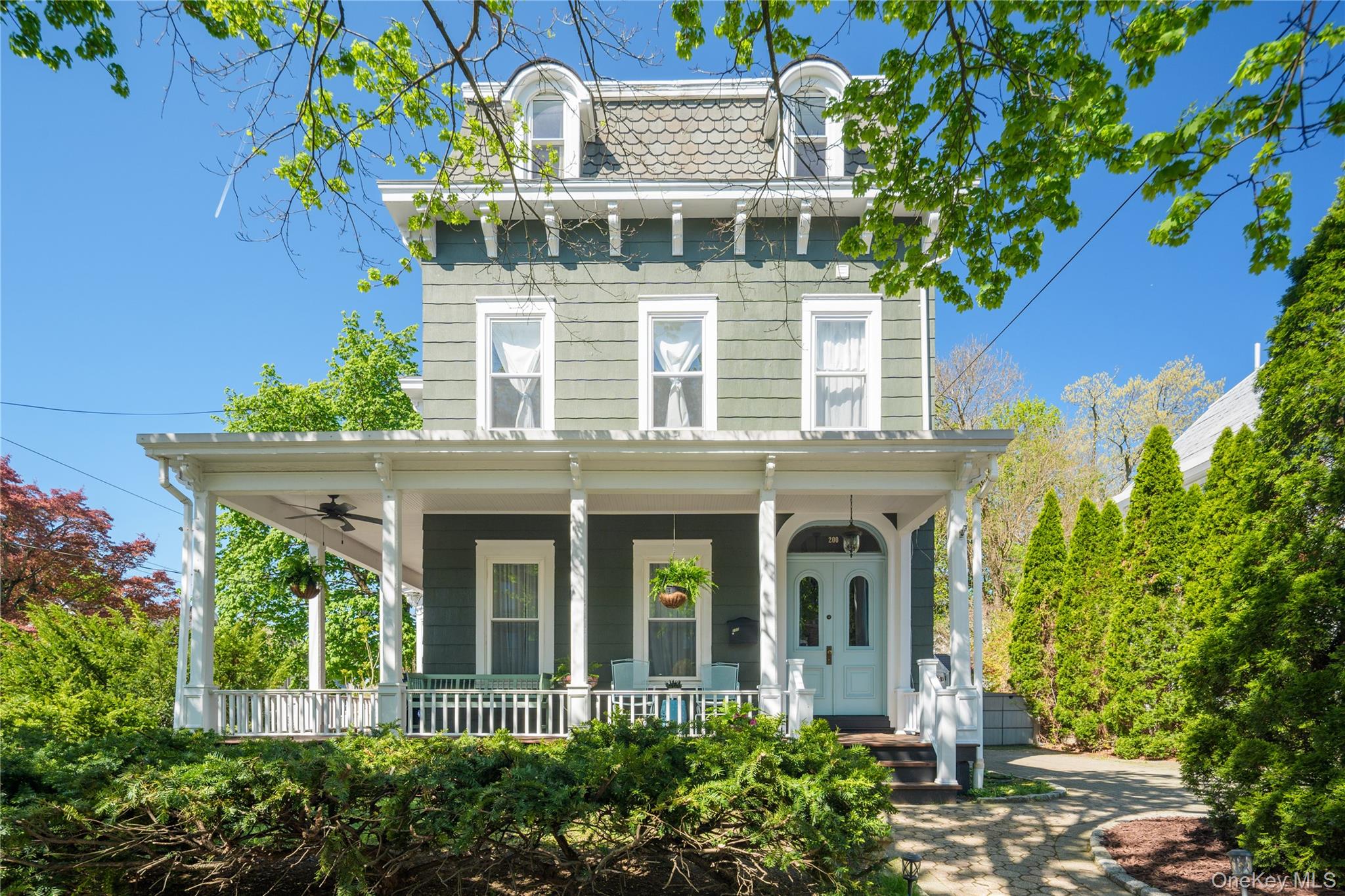 Step into timeless elegance at this historic 3-level Victorian in the heart of Peekskill. Offering over 2500 sq ft with 5 spacious bedrooms and 2 updated baths, this home beautifully blends classic charm with modern living. Rich in original details, from wide plank oak and bamboo wood floors to soaring high ceilings, every corner tells a story, and artful updates ensure comfort and convenience for modern living. The kitchen, renovated in 2025, features stainless steel appliances, quartzite countertops, marble backsplash, pantry and thoughtful design, seamlessly connected to a flexible floorplan ideal for today’s lifestyle. Sunlight pours through new windows, enhancing the home’s warm, inviting atmosphere. Updated bathrooms, creative paint colors, hvac mini-split units and WiFi-enabled thermostats add a contemporary touch. Enjoy your morning coffee on the welcoming wraparound front porch or unwind on the back patio in the lovingly designed and well-maintained gardens. Additional highlights include a mudroom, new whole-house water filtration system, meticulously restored Victorian cast iron radiators, natural gas, and municipal sewer. Perfectly located on a sought-after street, just two short blocks to Peekskill’s vibrant downtown. Peekskill Coffee House, The Paramount Theater, Bruised Apple Books, Birdsall House and other dining, shopping, and entertainment options abound. Metro North train to Manhattan is less than five minutes’ drive. Full of personality, charm, and curb appeal-this is a truly special place to call home.