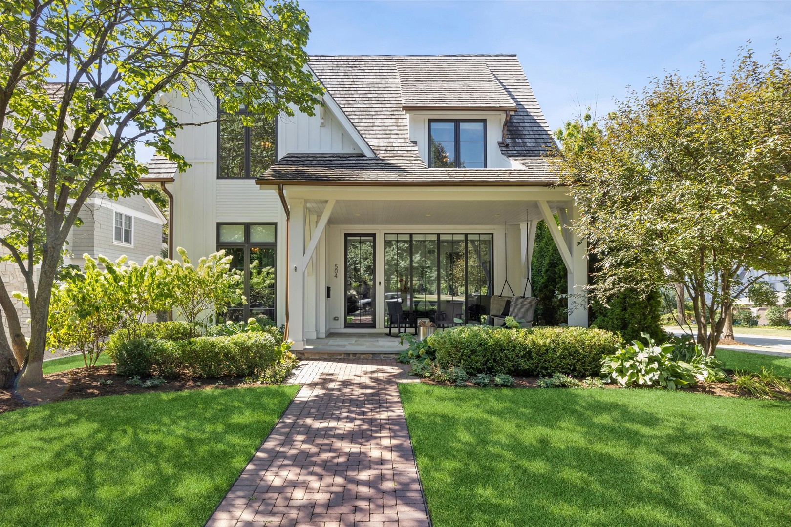 An exceptional blend of refined design, modern functionality and unexpected lifestyle amenities, this distinctive Hinsdale home offers beautifully finished living spaces just blocks from the heart of town. Built by Garber with architecture by Moment, the home pairs timeless curb appeal with a sophisticated, light-filled interior and an extraordinary multi-level lower level complete with its own indoor sport court. A bluestone front porch welcomes you inside, where hardwood floors, expansive windows and thoughtfully designed built-ins create an elevated yet comfortable atmosphere throughout.    Just off the foyer, a private office/lounge with glass double doors and custom built-ins provides an ideal work-from-home setting, while the adjoining dining room is framed by dramatic floor-to-ceiling windows. A temperature-controlled glass-enclosed wine room adds a striking architectural element and creates a memorable transition into the home's main entertaining spaces. At the heart of the home, the beautifully updated kitchen features marble countertops, custom cabinetry and an impressive suite of Sub-Zero and Wolf appliances, including a six-burner range with griddle and double ovens, along with a Miele dishwasher. A built-in breakfast banquette creates an inviting spot for casual dining.    The adjoining family room has also been thoughtfully reimagined and centers around a gas fireplace, with expansive glass doors opening to the outdoor living spaces beyond. A well-designed mudroom provides everyday functionality and connects through a covered brick portico to the detached two-car garage.    Upstairs, the primary suite is a serene retreat with hardwood flooring, a generous walk-in closet and a beautifully updated bath featuring heated floors, marble countertops, dual vanity, freestanding soaking tub and an oversized glass-enclosed steam shower with bench. Three additional second-floor bedrooms include two with walk-in closets connected by a Jack-and-Jill bath and a vaulted ensuite bedroom with its own walk-in closet. A spacious second-floor laundry room with sink completes the level. The third floor adds tremendous flexibility with an open bonus/loft space, double-door closet and full bath-ideal for a studio, music room, playroom or additional private living space.    Then comes one of the home's biggest surprises. The expansive lower level unfolds across multiple levels and was designed for recreation and entertaining on an entirely different scale. The main level offers generous media and lounge spaces alongside a sleek wet bar with bar seating, sink, beverage refrigeration and ice maker. A private bedroom with egress window and full bath provides excellent accommodations for guests. Continue down to a dedicated recreation/sensory gym outfitted with climbing walls and activity equipment before arriving at the showstopper: a private indoor sport court with basketball hoop. It's an exceptional amenity rarely found this close to downtown Hinsdale.    Outside, the recently redesigned backyard creates another extension of the home's entertaining space, with new hardscape and landscaping surrounding a generous brick paver patio and built-in fire pit. Mature landscaping provides a beautiful backdrop, while the home's architectural details, covered portico and detached garage give the property the character of a thoughtfully designed private compound.    Additional highlights include Sonos sound system, a whole-house Generac generator, lawn irrigation, fire sprinkler system, water purification and softening systems, and dual HVAC systems. Ideally situated in a coveted walk-to-town location near Hinsdale's shops, restaurants and train, and served by Oak Elementary, Hinsdale Middle School and Hinsdale Central, 504 S. Lincoln delivers the rare combination of newer construction, sophisticated design and truly exceptional recreational space-all in the heart of Hinsdale.