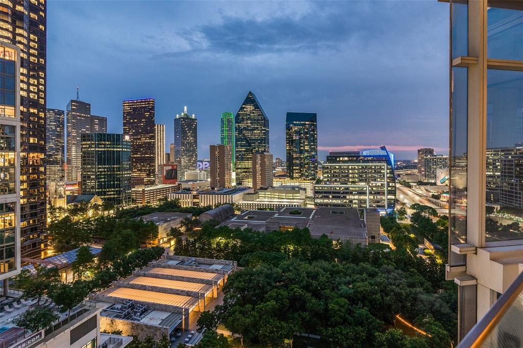 Designed by renowned designer Allen Kirsch, this one-of-a-kind Museum Tower residence overlooks Klyde Warren Park and Texas Stock Exchange with spectacular floor-to-ceiling views of the Downtown Dallas skyline. A private elevator opens to a custom foyer with storefront glass and steel-framed doors. Exceptional finishes include slightly scraped oak floors, rift and quartered walnut paneled walls and recessed cabinetry, Philip Jeffries wall coverings, and designer lighting with art lighting, chandeliers, pendants and sconces. The open-concept living and dining areas flow into a contemporary kitchen with premium appliances, sleek cabinetry, generous storage and a large island. Custom dry bar with marble countertop, Sub-Zero wine chiller and liquor storage. Rare, dedicated office with marble desktop, built-in file cabinets and pull-out printer drawer. Spacious primary suite features panoramic skyline views, blackout drapes, spa-inspired bath and custom walk-in closet with floor-to-ceiling window. Reimagined utility room with workspace, sink and Crystallo quartzite countertops. Crestron smart home controls Lutron lighting, shades, climate and AV. Brivo access, cameras and ADT security. Museum Tower amenities include 24-7 concierge and valet, two house cars, fitness center, pool, saunas, guest suites, dog park, dog walking services and resident social events. Includes four parking spaces.