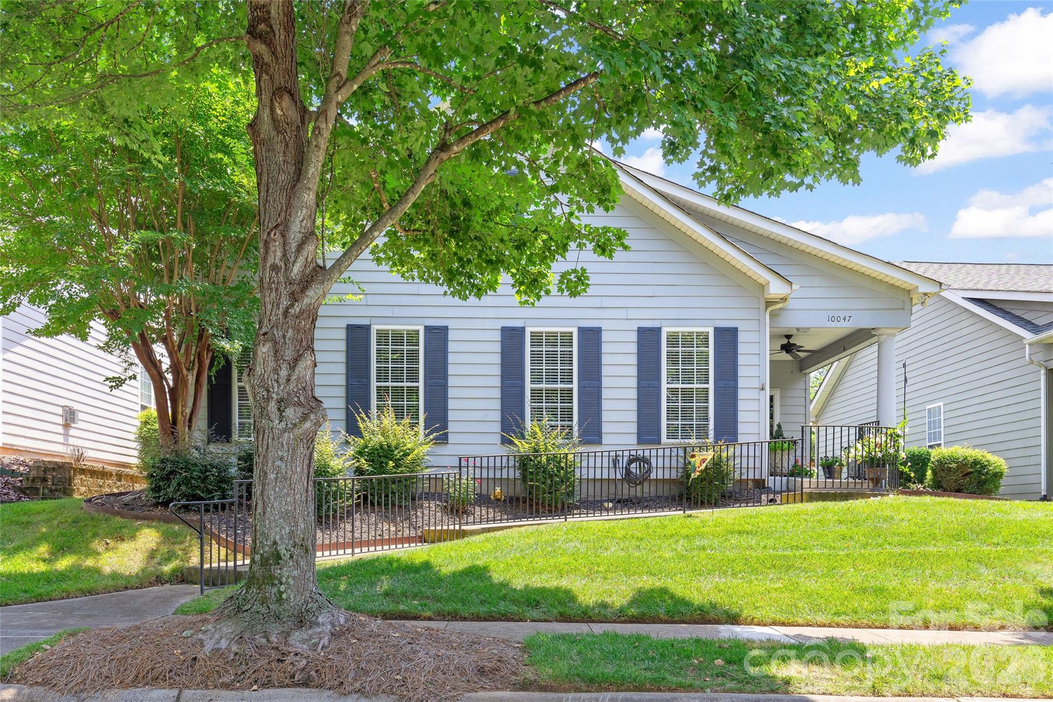 Welcome to 10047 Bishops Gate Boulevard in The Cottages, a gated 55+ community in the heart of rapidly growing Pineville. This sought-after split-bedroom floor plan offers two spacious bedrooms, two full baths, and a versatile office/flex room that appeals to today's buyers and renters alike. Recent improvements enhance value including gorgeous flooring, solid surface kitchen countertops, and an updated furnace. Space above the two car detached garage offers unfinished storage! Outside, enjoy a newly fenced private backyard, covered porch and patio that provide peaceful outdoor living. Residents enjoy exceptional amenities including a gated entrance, clubhouse, fitness center, and community pool, while the convenient location offers quick access to I-485 and I-77, as well as nearby shopping and dining. HOA provides lawncare including shrubs, trash, water/sewer. Whether you're looking for a full-time residence, a lock-and-leave seasonal home, or a low-maintenance investment, this is your opportunity to purchase a turnkey property in one of the Charlotte area's popular active adult communities. With limited inventory, a welcoming lifestyle, and residents who genuinely love living here, this home is well-positioned for lasting value and continued demand.