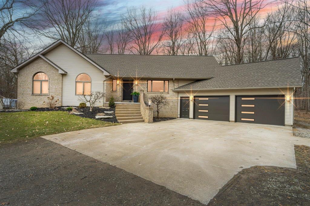 Back on market with renewed appeal and fresh updates! This stunning custom home on 5 wooded acres blends contemporary elegance with natural beauty. Vaulted ceilings, abundant light, and cork flooring set the tone. The designer kitchen features quartz counters, Subzero appliances, and a charming coffee bar. The primary suite offers a spa-like ensuite with soaker tub, rainfall shower, heated floors, and WIC. Finished daylight lower level adds a 2nd kitchen w/bar, guest suite, and huge living space. Enjoy a large deck, built-in fire pit, park and trail access perfect for entertaining or just relaxing after work. Newer roof ('18), furnace ('20), and heated garage with storage. A rare opportunity.