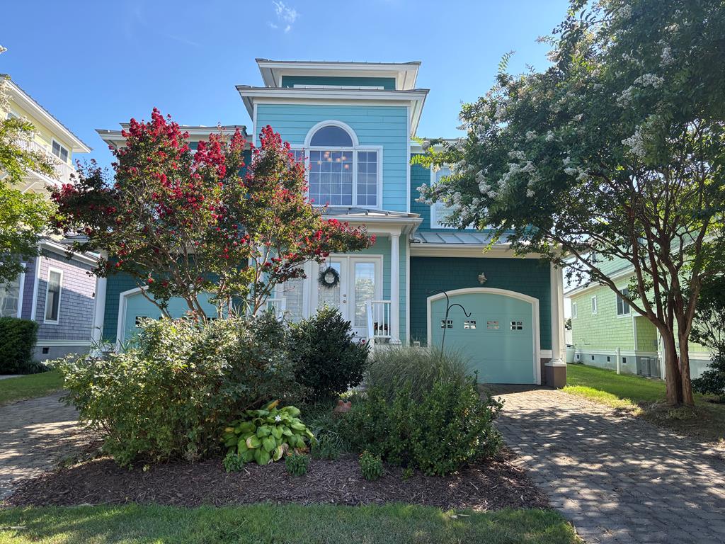 Houses like this don't come on the market often—don't miss your chance to own this 3-bedroom, 3-bath coastal retreat in the sought-after gated community of Bay Creek. Perfect vacation getaway, year-round residence, or investment property. The first floor features a primary suite with walk-in closet, a 2nd bedroom and full bath, plus a convenient laundry room. Upstairs, enjoy an open-concept living room and kitchen, third bedroom and bath, and a versatile office/bonus room. The third floor offers stunning views—ideal for a game room, guest loft, or relaxing hideaway. Upgrades-luxury vinyl plank flooring throughout, a new HVAC system, and a new commercial-grade water heater. Two garages, decks on both levels, and access to private beaches, pools, and tennis courts, this charmer won't last!