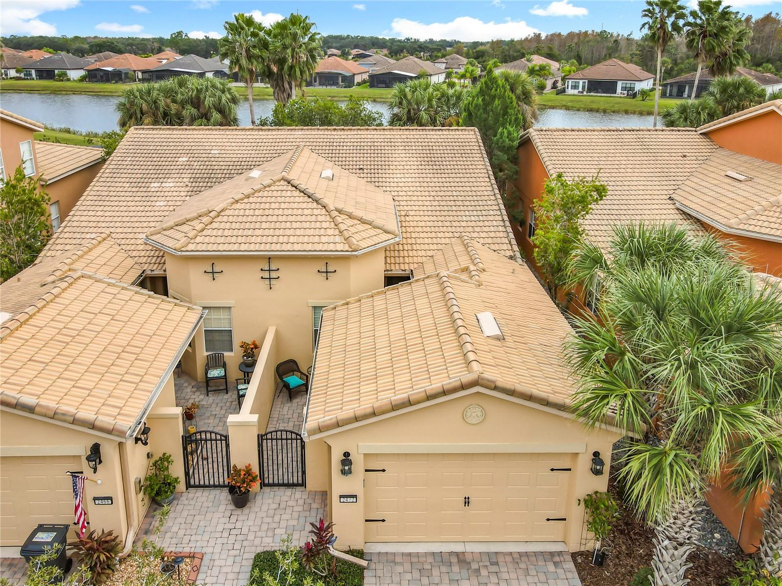 EXQUISITE WATERVIEW VILLA WITH ELEGANT TILE ROOF!!! Experience refined living in this distinguished villa, perfectly positioned within the exclusive COURTYARDS OF MONTELENA. Just moments from the vibrant VILLAGE CENTER, residents enjoy effortless access to premier dining, curated events, and the weekly farmer’s market. The community’s world-class amenity center elevates everyday living with a state-of-the-art FITNESS CENTER FACILITY, RESORT-STYLE POOL, rejuvenating SAUNA and SPA, tennis and pickleball courts, a diamond softball field, playground, two dog parks, and beautifully maintained butterfly and vegetable gardens. Additional luxuries include a grand ballroom, golf shop, and an on-site convenience store with pharmacy services, bringing comfort and sophistication to your doorstep. This elegant CORTINA MODEL HOME features 1,539 square feet of refined interior living space, within a 1,999 square-foot total area designed for effortless, open-concept living. The residence highlights TWO PRIVATE OUTDOOR RETREATS, beginning with a generous FRONT COURTYARD, an inviting sanctuary ideal for savoring Florida’s sunshine, dining alfresco, entertaining, or cultivating your own garden oasis and a WATERVIEW SCREENED LANAI!!! Thoughtful upgrades enhance comfort and wellness, including a WATER SOFTENER SYSTEM and an HVAC UV germicidal lamp to support superior indoor air quality. Exterior maintenance is made worry-free, with annual roof and exterior power washing and professional exterior painting every seven years, all included as part of your HOA services. An inviting interior highlights TWO bedrooms, TWO full bathrooms, and a versatile FLEX ROOM thoughtfully converted into a third bedroom. The open layout is beautifully complemented by tile flooring throughout. The open-concept kitchen seamlessly connects to the expansive 28' x 14' great room, creating an ideal setting for both everyday living and effortless entertaining. The GOURMET KITCHEN makes a striking impression with its CORIAN countertops, STAINLESS STEEL appliances, 42-inch cabinetry, recessed lighting, and a BREAKFAST BAR. The OWNER'S SUITE captures tranquil WATER VIEWS and features a generous WALK-IN CLOSET along with a beautifully appointed EN-SUITE BATH, complete with DUAL SINKS, a GLASS-ENCLOSED WALK-IN SHOWER, a linen closet, and a private water closet. A well-designed SPLIT FLOOR PLAN provides exceptional privacy between the owner’s suite and the guest bedroom. The expansive great room opens to a screened and covered lanai with serene water views, an ideal setting for peaceful outdoor living and enhanced privacy. Completing the home is a spacious garage accommodating one car plus a golf cart bay, enhanced by OVERHEAD STORAGE SHELVING and complemented by an expansive driveway. 55+ Gated Golf Community of Solivita offers an impressive array of amenities, two PGA 18-holes Championship golf courses, two State of the Art Amenity Centers, fourteen pools, restaurants, tennis court, playground, dog park, and over two hundred different clubs. Near supermarkets, restaurants, pharmacies, hospital, new express way, just 25 minutes to major attractions, and the new Sun Rail Poinciana Station.  If you are interested in the property, it is a clever idea to schedule a video virtual showing or arrange for a private showing to see it in person. A physical tour can provide a better sense of the space, layout, and overall feel of the property.