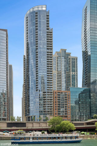 Live the lakefront luxury lifestyle in this stunning corner residence at The Regatta in Lakeshore East. Perched on the 14th floor, Unit 1410 offers breathtaking panoramic views of the Chicago River, Lake Michigan, Navy Pier, and the glittering city skyline through floor-to-ceiling windows and from your private balcony. This impeccably maintained 2-bedroom, 2.5-bath home offers elevated living space, designed with refined finishes and an open-concept layout perfect for both entertaining and everyday elegance. Enjoy rich hardwood floors, a cozy fireplace, and a chef's kitchen featuring stainless steel appliances, granite countertops, 42" cabinetry, and a breakfast bar. The primary suite is a serene retreat, complete with generous closet space and a spa-like en-suite bath. A second bedroom with en-suite bathroom, a stylish powder room, and in-unit laundry complete the home's thoughtful design. Life at The Regatta means resort-style living every day. Residents enjoy 24-hour door staff, an indoor pool, whirlpool, state-of-the-art fitness center, media and game rooms, a party lounge, and an expansive outdoor sundeck. Just steps from the lakefront, Millennium Park, Maggie Daley Park, Mariano's, and the Riverwalk - this is urban living at its finest. Parking space available for $45,000.