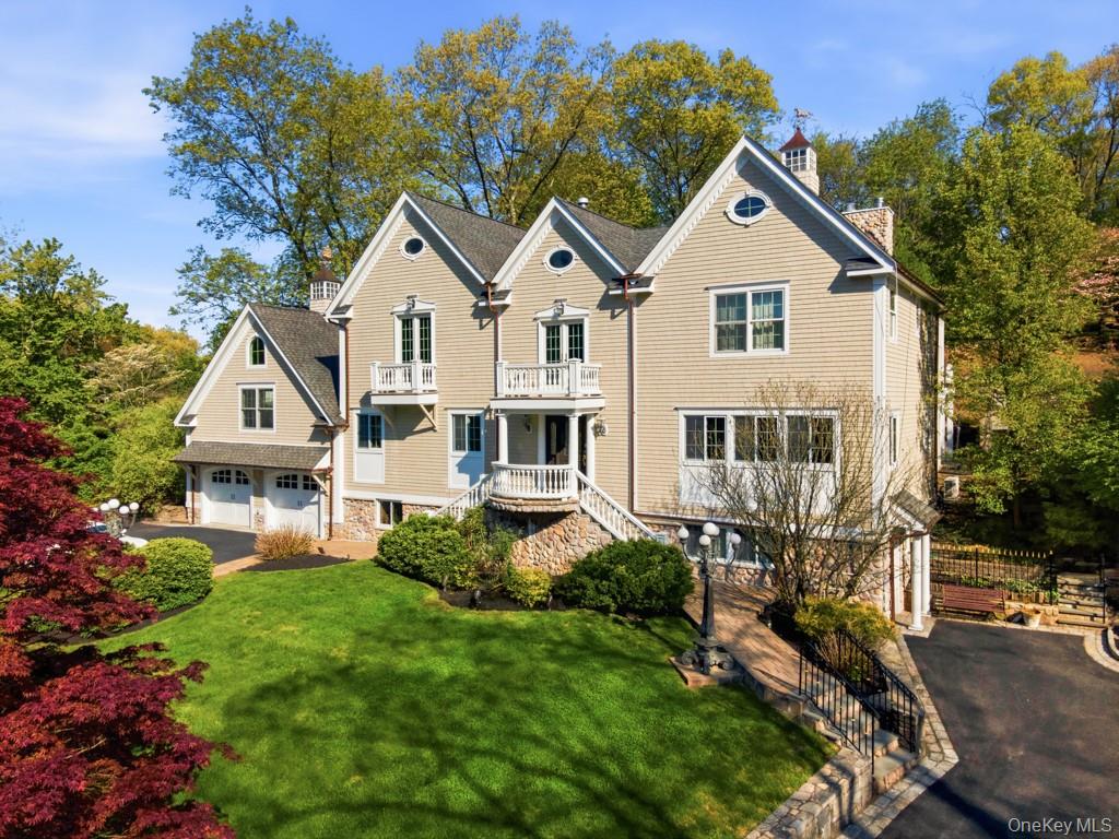Set on beautifully landscaped grounds in one of Chappaqua’s most coveted neighborhoods, this exceptional luxury Colonial blends timeless architecture, designer finishes, and an unmatched indoor-outdoor lifestyle within the award-winning Chappaqua school district. Privately positioned against acres of preserved land, this premier Westchester County property offers both tranquility and convenience, just minutes to Metro North, downtown Chappaqua, and Chappaqua Crossing featuring Whole Foods Market and Life Time. Living like a 5-bedroom home, this luxury home for sale in Chappaqua showcases exceptional craftsmanship throughout with Juliet balconies, copper-topped cupolas, Belgian block-lined driveways, soaring ceilings, custom millwork, and walls of glass that flood the interiors with natural light. A dramatic curved staircase welcomes you into elegant yet comfortable living spaces designed for both everyday living and sophisticated entertaining. The chef’s kitchen is beautifully appointed with premium Wolf and Sub-Zero appliances, custom cabinetry, and European mosaic tilework, seamlessly connecting to the formal and casual gathering spaces. Highlights include a sophisticated library with gas fireplace, a stunning vaulted family room, and an impressive entertainment lounge with a wood-burning fireplace, wet bar, Viking wine refrigerator, and custom built-ins. The luxurious primary suite offers a gas fireplace, oversized dressing room, and spa-inspired bath, delivering the ultimate private retreat.Outside, the property lives like a private resort with a heated saltwater pool, outdoor fireplace, expansive patios, built-in grill, fire pit, poolside grotto with shower and changing area, gazebos, and a half basketball court with spotlighting. This exceptional Chappaqua estate offers luxury living, privacy, and resort-style amenities in one of Westchester’s most sought-after communities, known for top-rated schools, vibrant downtown, and easy NYC commute. A rare opportunity to experience estate-style living and the quintessential Chappaqua lifestyle at its finest.