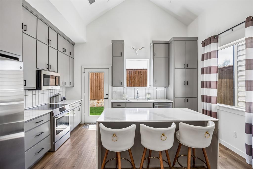 Motivated Seller! Great location to Southlake, DFW airport! Primary Bedroom downstairs! Experience modern living in Tillery Commons, offering a refined lock-and-leave lifestyle in the heart of the Grapevine area. Designed with clean modern lines and surrounded by more than three acres of greenbelt open space, this fully decorated new construction home blends thoughtful design with everyday comfort. A striking brick and siding elevation welcomes you into an open living plan highlighted by soaring 20-foot ceilings in the family room and an abundance of natural light. The spacious living area flows seamlessly into the dining space and a beautifully designed kitchen featuring a waterfall island, custom painted wood cabinetry, and a Bosch electric range, creating a stylish and functional gathering place for everyday living and entertaining. The primary bedroom is conveniently located on the main level and offers a luxurious ensuite bath designed for relaxation. A dedicated office with a beautiful window provides an ideal workspace for working from home. A powder bath is also located on the main floor for guests. Upstairs, you’ll find two additional bedrooms and a lofted game room, offering flexible space for recreation or additional living. A walk-in attic provides valuable storage. This thoughtfully built home also includes spray foam encapsulation for enhanced energy efficiency, a fire suppression system, and custom pull-down shades for the upper living room windows. Residents of Tillery Commons enjoy low-maintenance living with HOA-maintained front yards, along with the beauty of nearby greenbelt spaces. Located just minutes from shopping, dining, entertainment, and the airport, this community offers convenience, style, and modern comfort in one exceptional setting. 3D tour online.