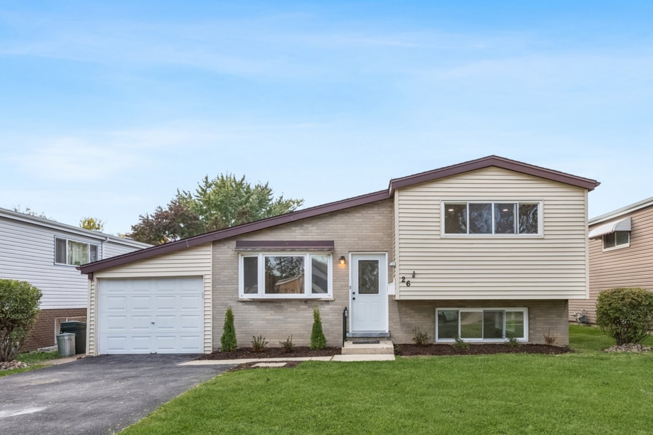 Welcome home to effortless style and modern comfort in this beautifully renovated Lombard residence. Blending timeless charm with today's most desired finishes, this home is thoughtfully designed for both everyday living and entertaining.The main level opens to an inviting, open-concept living and dining space that flows seamlessly into a show-stopping kitchen. Crisp white cabinetry, quartz countertops, stainless-steel appliances, and a generous island with seating and storage create a space as functional as it is beautiful-ideal for gatherings or quiet mornings at home. The lower level offers a bright and welcoming family room, a convenient powder room for guests, and a dedicated utility and laundry area. Privately set apart, the primary suite feels like a true retreat, featuring a spa-inspired ensuite with dual-sink vanity, oversized shower, ample closet space, and abundant natural light. Just outside the suite, a flexible den or office provides the perfect spot for working from home, reading, or unwinding.    Up a short flight of stairs, three additional bedrooms showcase beautifully refinished hardwood floors and share a stylishly updated hall bath. New windows throughout the home enhance comfort, efficiency, and natural light. Step outside to a spacious backyard-ideal for entertaining, play, or simply relaxing outdoors. All of this is just steps from downtown Lombard's charming shops, restaurants, and Metra station. Beautifully updated, perfectly located, and ready for you to move confidently into your next chapter.