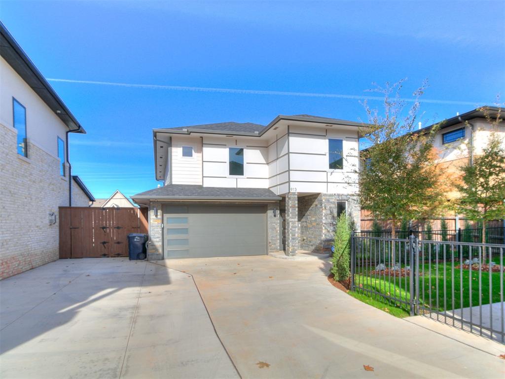 Stunning modern construction in the heart of Western District and Crown Heights! Barely lived in and ready to greet its new owner, this 4 bedroom 2.5 bath home is the perfect blend of modern design and warm Oklahoma living. The Stone & siding exterior welcomes you as you pull up to the low maintenance lot. Inside, you're greeted with warm white oak floors throughout the first floor. Upgraded quartz countertops and designer selected lighting complete the look all around. The spacious living room anchored by the fireplace opens into the dining and kitchen areas. The Kitchen is a cooks dream featuring Fisher and Paykel Range/Oven along with built-in microwave and stainless steel dishwasher. The kitchen Island is accented with Black Faucet and copper tinted divided sink.  Wood floors extend up the stairs where you find carpeted bedrooms and spacious bathrooms complete with Black fixtures/hardware and Marble countertops. The primary bedroom with en-suite is a great place to unwind complete with walk-in shower and freestanding garden tub. If you've been looking for low maintenance newer construction in the heart of OKC, then you've found it! HOA includes all lawn & landscape maintenance year round. Welcome Home!