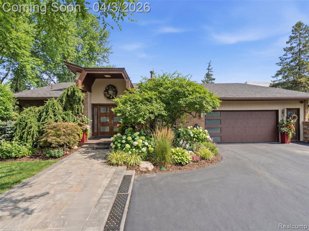 Nestled in the highly desirable Walnut Lake Hills subdivision, this distinctive contemporary quad-level home offers access to a private beach, park, gazebo, and boat docking (by rotation) on all-sports Walnut Lake—just a short walk away.Featuring one-of-a-kind architecture, the home showcases soaring ceilings, an open floor plan, and expansive windows that flood the interior with natural light. The flexible layout includes a formal dining room, den, and a dramatic great room anchored by a striking stone fireplace with built-in features.The bright white kitchen combines style and function with granite countertops (2022), an artistic china backsplash, stainless steel appliances (2022), and a wine cooler (2022).The entire upper level is dedicated to a luxurious primary suite retreat, complete with a massive closet, dressing area, and a beautifully remodeled bath (2023) featuring a tub, shower, and private balcony. One level below, a private three-bedroom wing with a full bath offers ideal separation for family or guests.The finished walk-out lower level expands the living space with a family room, full bath, bar area, cedar closet, and abundant storage. Additional fireplaces installed in 2023 enhance the ambiance in the primary bedroom, den, and lower level.This home has seen extensive updates, including interior and exterior painting (2022), new roof and gutters (2023), two furnaces and two air conditioning units (2023), carpet throughout (2023), vinyl basement flooring (2023), and a stunning front entry with travertine marble flooring (2024). Outdoor improvements include a new walkway and back patio (2024), updated landscaping with lighting (2024), and a freshly blacktopped driveway (2025).Situated on a quiet cul-de-sac, this property offers incredible potential—blending major mechanical and aesthetic updates with the opportunity to further personalize and elevate its unique design.Located within the highly acclaimed Bloomfield Hills School District, this is a rare opportunity to own a truly special