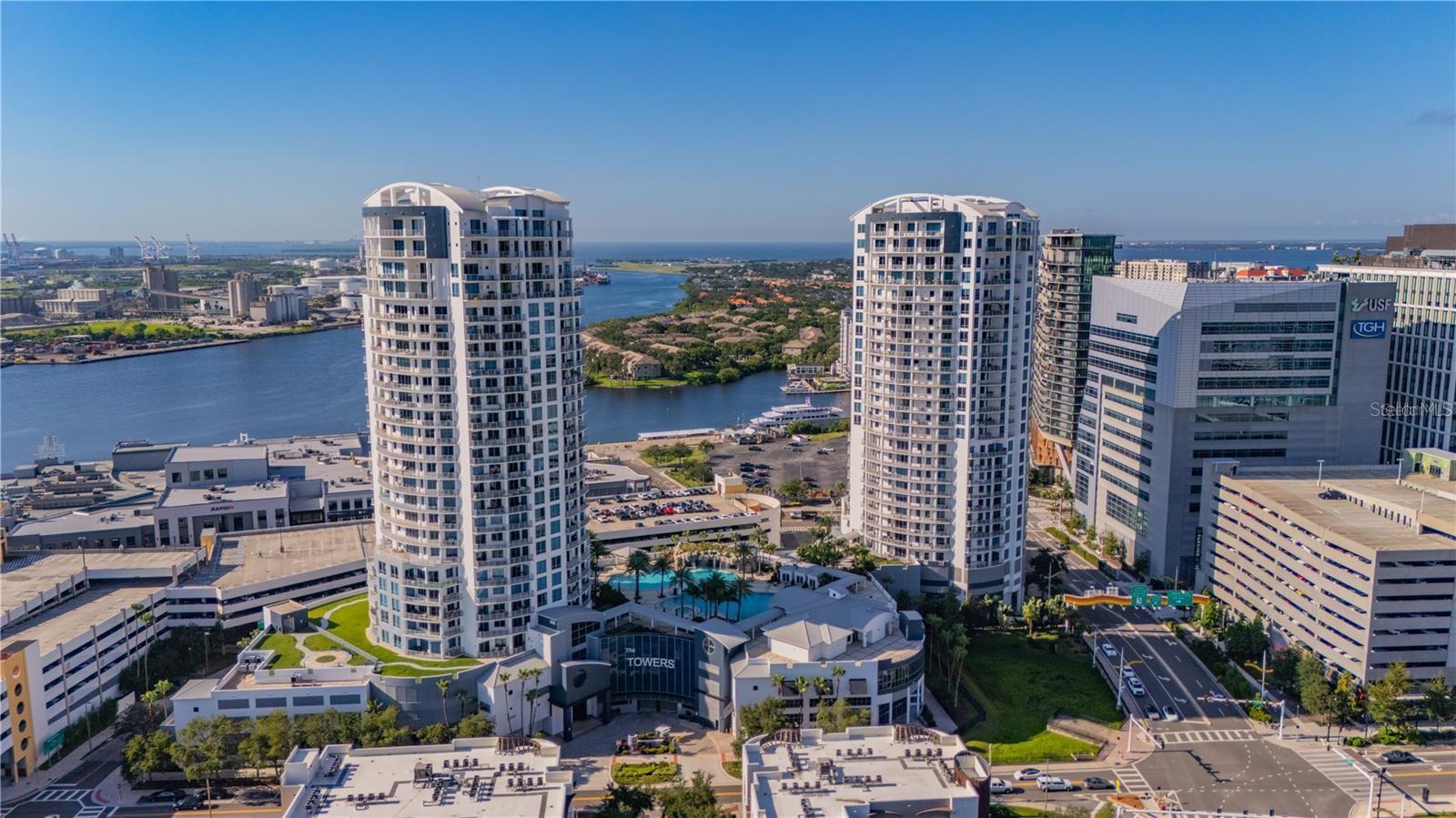 LOCATION! LOCATION! LOCATION!Live in the heart of Downtown Tampa in this stunning 9th-floor 1 bedroom, 1.5 bathroom condo with den and breathtaking water and skyline views. This beautifully designed residence features an open-concept layout with hardwood and tile flooring throughout, plus a spacious wrap-around balcony perfect for soaking in the city and waterfront scenery. The chef-inspired kitchen boasts stone countertops, stainless steel appliances, and a stylish bar area ideal for entertaining. The generously sized primary bedroom includes a private ensuite bathroom, while the versatile den offers the perfect space for a home office or guest area with convenient access to the guest bath.Enjoy true resort-style living at The Towers at Channelside, featuring a gorgeous pool with cabanas, poolside bar, and large TV, two dog parks with a dedicated dog wash station, resident clubhouse, 24/7 security, concierge services, and more. Ideally located between Water Street and the Channelside District—just steps from Amalie Arena, Sparkman Wharf, Tampa Aquarium, the cruise port, top restaurants, shopping, and all the excitement of vibrant Downtown Tampa. Pets considered on a case-by-case basis with owner approval.