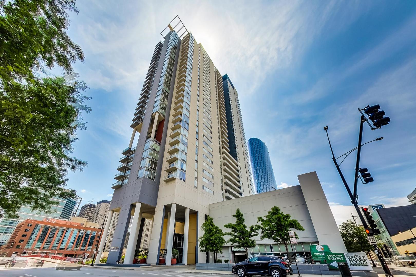 Spacious & Sunny Skybridge! With East-facing floor-to-ceiling windows and fabulous views of the city & on one of the best blocks in the West Loop! Bright kitchen with breakfast bar, cabinets galore, granite counters, & newer appliances. Spacious primary suite easily accommodates a king-size bed and boasts large walk-in closet. Primary bath has separate shower and deep soaker tub. 2nd bath across from 2nd BR for convenient split floorplan! Additional unit highlights include: hardwood floors, newer BR carpeting, loads of recessed lighting, and newer side-by-side WD. Large east balcony right off the living room with an amazing city view perfect for relaxing or hosting. Tons of storage, including an additional HUGE basement storage locker. High-amenity building with includes heat/water/cable/internet/updated gym, very strong reserves, investor friendly, plus great amenities (door staff, rooftop deck and rooftop fitness center, dog run, & bike racks). 2 Indoor heated parking spaces available! You will LOVE this West Loop location!