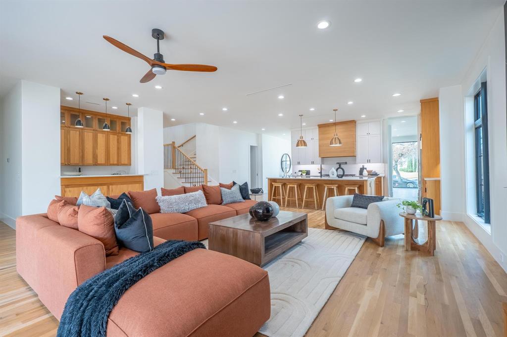 Introducing a refined modern-traditional new construction on one of Lakewood’s most sought-after streets. Thoughtfully designed for both everyday living and effortless entertaining, the main level features an expansive open-concept layout with impressive ceiling heights and seamless flow between the living, dining, and kitchen spaces. The chef’s kitchen is anchored by a full suite of Fisher & Paykel appliances, including a 48” range, built-in microwave drawer, and generous counter and storage space.The primary suite is conveniently located on the first floor, offering privacy and ease of access, alongside a well-appointed mudroom and laundry room. Upstairs, a spacious second living area serves perfectly as a game room, media space, or play zone. Four additional bedrooms, beautifully finished bathrooms, and a flexible office or potential sixth bedroom complete the upper level.Set on a prime corner lot and offering more than 5,200 square feet of living space, this home provides exceptional scale, natural light, and room to grow. A rare opportunity to own a sophisticated new build in one of Dallas’ premier neighborhoods.