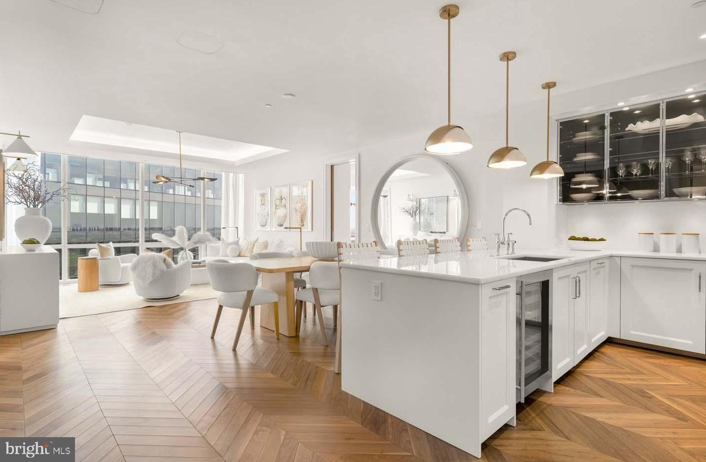 TWO BEDROOM + DEN/OFFICE AVAILABLE!Welcome to the Four Seasons Private Residences in Harbor East, where luxury meets lifestyle in Baltimore’s most coveted waterfront address. This stunning two-bedroom, two-bathroom unit comes with a designated light-filled den/office and was thoughtfully designed to maximize every inch, making it live far larger than its 1,486 sq ft. Step into an atmosphere of sophistication with soaring ceilings, rich walnut chevron-patterned flooring, and curated designer finishes throughout. Expansive floor-to-ceiling windows flood the home with natural light and offer breathtaking views of the Inner Harbor and iconic Domino Sugar sign from every room. The open-concept living and dining areas flow seamlessly into a gourmet kitchen outfitted with Miele appliances, sleek Eggersmann soft-close cabinetry, luxurious marble stone countertops, and a built-in Sub-Zero wine fridge. The primary suite is a tranquil retreat, featuring two custom-built walk-in closets and a spa-inspired, marble-clad en-suite bath. Enjoy a double vanity with designer finishes, private water closet, glass-enclosed walk-in shower with a built-in bench and niche, and a sculptural freestanding soaking tub that invites total relaxation. The spacious den (accessible from both the guest suite and living room) provides flexible use as a home office, library, or media room, and every space is enhanced with expansive views that change with the light.The Four Seasons Private Residences Baltimore offers a turn-key elevated lifestyle. As a resident, you'll enjoy a private entrance where you will be met by our full service concierge and on-site building manager to assist with your every need, as well as exclusive access to the sprawling 28th-floor amenity level, where world-class services meet resort-style indulgence. Amenities include an indoor heated saltwater infinity-edge pool, a state-of-the-art fitness center, sauna, coffee station, billiard room, and numerous elegant gathering spaces. Multiple rooftop decks offer panoramic city and harbor views, complete with indoor and outdoor fireplaces, a grilling station, a dining area, and a kitchen, all ideal for entertaining. Additional perks include a fully equipped conference room and a dedicated AstroTurf dog-walking area. This residence offers the rare opportunity to live within a full-service, hotel-branded building while enjoying the privacy and sophistication of a true luxury home. All set within steps of Harbor East’s acclaimed restaurants, shopping, and the waterfront promenade. This is a MUST SEE TWO BEDROOM + DEN!! Immediate occupancy is available. Come see what all the fuss is about!