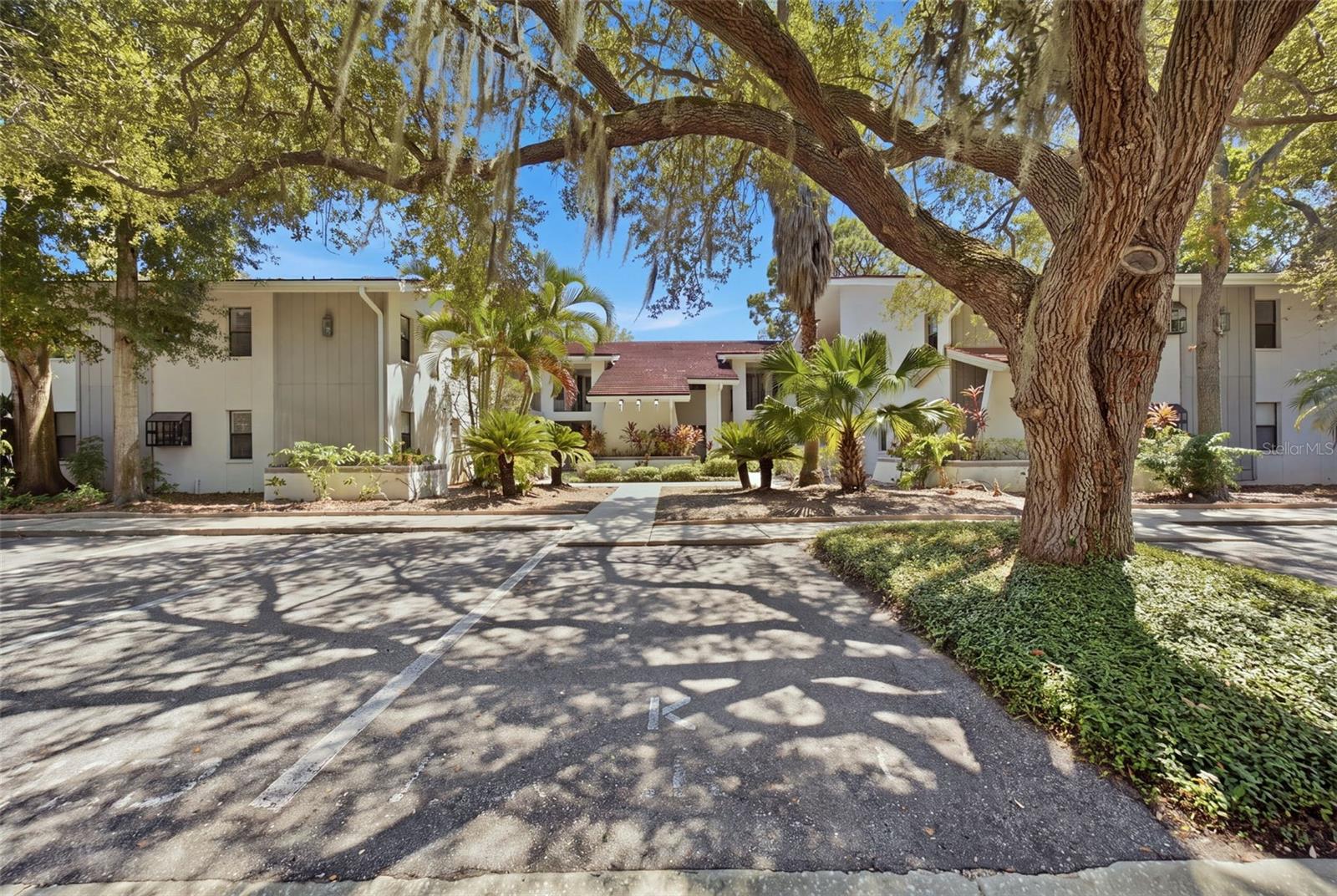 Some Photos are virtually staged.  Welcome to Sunset Shores, where coastal living meets completely remodeled, move-in-ready convenience! This beautifully updated second-floor condo features 2 bedrooms and 2 bathrooms with no upstairs neighbors and assigned parking located right in front of the unit.Step inside and you’ll immediately notice how light, bright, and spacious this home feels. Soaring ceilings in both the living room and primary bedroom add to the open, airy feel, while the open floor plan provides plenty of room for entertaining, relaxing, or hosting friends and family. Stylish wood-look flooring runs throughout, complemented by quartz countertops in the beautifully updated kitchen and bathrooms. The kitchen has a clean, modern feel and flows seamlessly into the dining and living areas, creating one spacious gathering space.The primary suite is a standout, with soaring ceilings, plenty of natural light, generous storage, and an updated private bathroom. An in-unit washer and dryer adds everyday convenience, making this home truly ready for you to move in and start enjoying.Sunset Shores offers resort-style amenities including a solar-heated pool, fitness center, game room, tennis and pickleball courts, BBQ grills, and a community dock overlooking the Gulf of America and Sunset Park.The location is another highlight. You’re just minutes from the famous Tarpon Springs Sponge Docks, known for Greek restaurants, bakeries, shops, waterfront dining, and the area’s rich history. Charming Downtown Tarpon Springs is also nearby, with walkable streets lined with local restaurants, breweries, boutiques, and community events. The Pinellas Trail, golf courses, parks, and Gulf Coast recreation are all within easy reach.With the HOA covering insurance, exterior maintenance and roof, water, cable, internet, trash, and recycling, you can spend less time worrying about upkeep and more time enjoying the Florida lifestyle.Completely remodeled, light and bright, no upstairs neighbors, and just minutes from some of the best that Tarpon Springs has to offer. Welcome home to Sunset Shores!