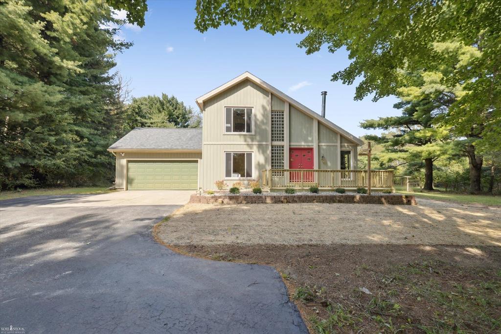 OPEN HOUSE Sunday, Sept 14 from 230pm to 4pm!  Beautiful contemporary home sitting back on 10 acres! Gorgeous new custom kitchen with modern solid surface tops and fixtures! Open living space featuring vaulted ceiling, free-standing wood stove and glass block accents. Hardwood floors throughout. Main floor bedroom and new bath with walk-in shower. The upper level offers a primary suite, with another new bath, plus an open flex space, perfect for office or possible 3rd bedroom. Partially finished basement. New roof, sliding door, decks on both the front and back of home and more! Many other updates in the last few years including siding, windows, furnace and skylights. 2-car attached garage, pole barn, garden areas, and even extra sheds for the chickens or goats!