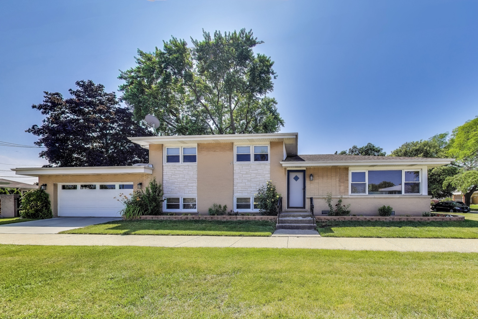 Beautifully maintained split-level home featuring a fully remodeled kitchen with abundant cabinetry, premium quartz countertops, and high-quality LG appliances. Enjoy two updated bathrooms and gleaming hardwood floors throughout. Recent upgrades include newer windows, furnace, A/C, and a completely renovated lower level. Ample closet and storage space, plus a new concrete driveway and concrete crawlspace. Situated on an oversized, fenced corner lot in a desirable location. Immaculately clean and move-in ready!