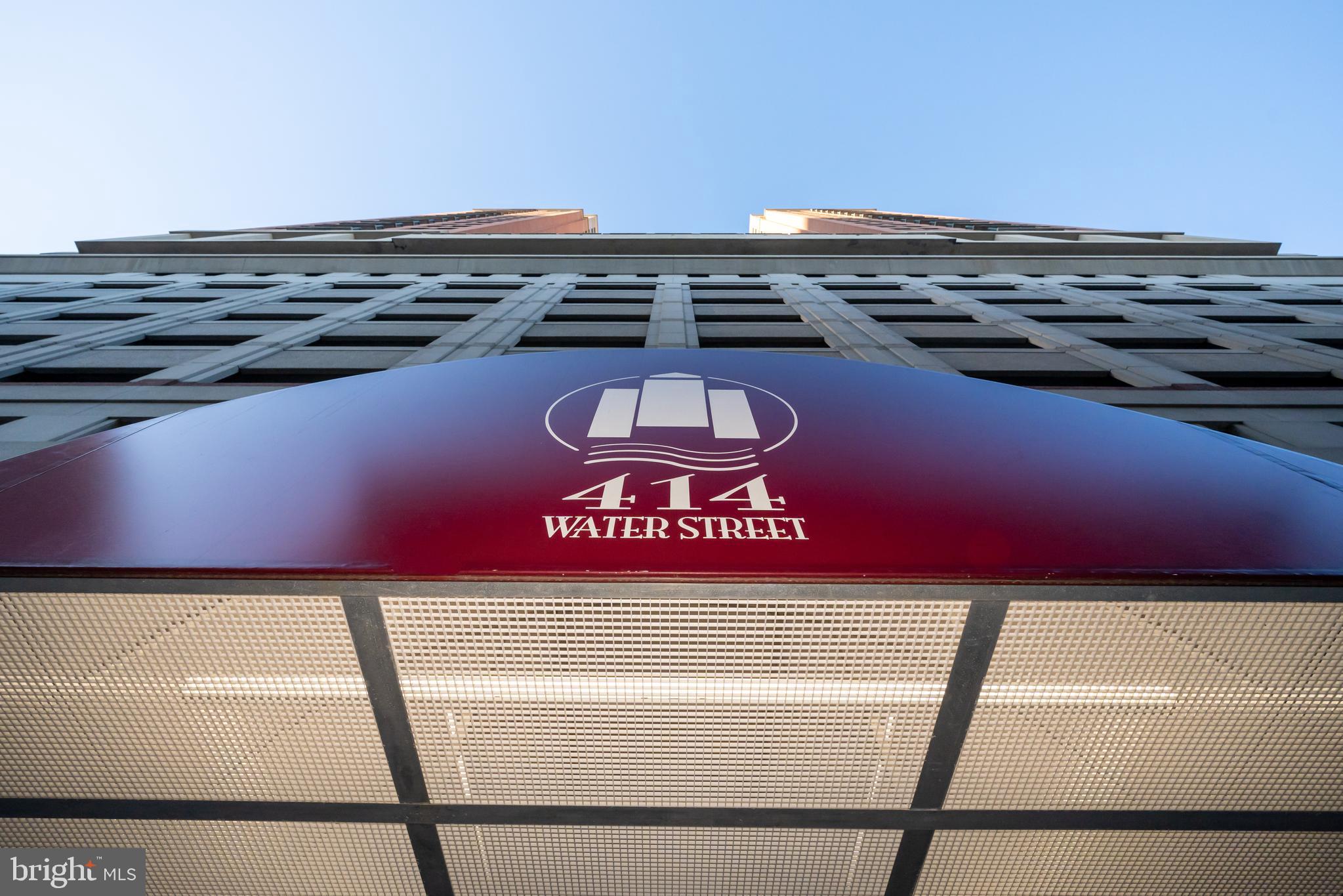 STOP RIGHT HERE! This front and center, harbor view home comes with 2 dedicated Parking Spaces in the garage!! Welcome to another fantastic home in the amenity rich, professionally managed 414 Water Street building.   414 Water Street is centrally located to everything happening in Baltimore's inner harbor with 24 hour live concierge service desk. Close to the Universities and Medical Centers;  walking distance to both stadiums and a quick ride to points on I 95/I-83  north and south. This unit is uniquely laid out with 2 large bedrooms each with a full bath on separate sides of the unit for increased privacy and hardwood floors throughout. The kitchen boasts stainless appliances, granite floors, lots of new fixtures and this impeccably maintained unit has been updated throughout.  Your own south facing, private balcony with outstanding harbor views and overlooking the outdoor/rooftop pool. offers lot of outdoor space to enjoy the seasons.   This home also has a lovely gas fireplace for some extra heat and ambiance on those colder nights.