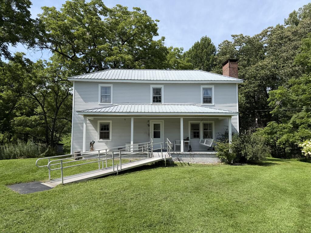 Enjoy the peace and privacy of country living at this beautiful two-story home situated on approximately 34 acres in Patrick County, Virginia. Located at 8211 Squirrel Spur Rd, Meadows of Dan, VA 24120.  This property offers a rare combination of comfortable living, open pasture, wooded acreage, abundant wildlife, and backs up to the Blue Ridge Parkway. The main level features a living room, bedroom, office, full bathroom, kitchen, dining room, laundry room, and mudroom, providing a practical and comfortable layout for everyday living or a peaceful mountain getaway. Upstairs, a spacious landing leads to two additional bedrooms, a bonus room, and a full bathroom. The home also includes an unfinished partial basement. The land is level to gently rolling and consists of approximately 14 acres of open fields and 20 acres of woods. Wildlife is abundant, making this an excellent property for those who enjoy hunting, nature, and the outdoors. Small Spring Branch on the East Boundary line-(Barnard Branch). The property backs up to the Blue Ridge Parkway. Enjoy your morning coffee from the front porch while taking in the sights and sounds of nature. Several outbuildings provide additional storage including a large building (32' x 40').  Property fronts on Squirrel Spur Road, a paved public road, while still offering the privacy and seclusion many buyers seek. Conveniently located near Meadows of Dan, Virginia, and Mount Airy, NC. This property offers the best of rural living while remaining within reach of nearby communities and amenities. Whether you're looking for a private country residence, weekend retreat, hunting property, farm, or recreational getaway, this 34 acre tract offers an exceptional opportunity in the beautiful Blue Ridge Mountains of Patrick County.