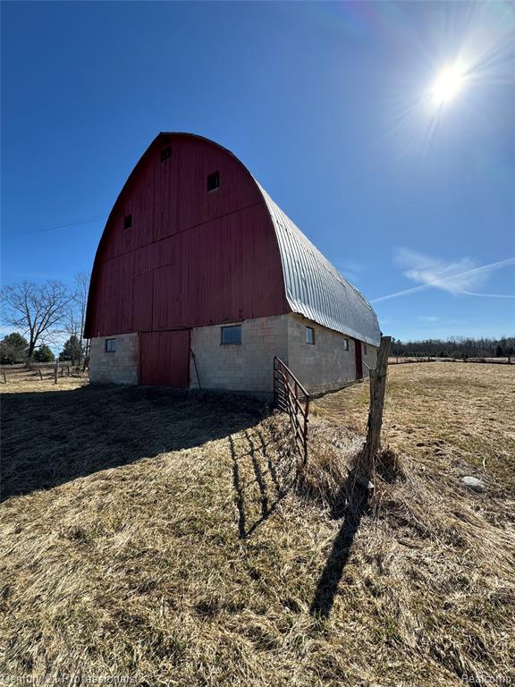 Tucked away in the heart of the Huron National Forest, 3608 State Rd. in Glennie, Michigan offers a rare opportunity to own a private Northern Michigan retreat where nature, history, and possibility come together across 18.5 scenic acres. This remarkable property invites you to slow down, unplug, and create something truly special.The land itself is a blend of mature forest, open pasture, and tranquil lake frontage, providing a picturesque setting in every direction. Fruit trees dot the property, while a newly planted line of arborvitaes adds future privacy and definition. Whether your vision includes peaceful mornings overlooking the water, evenings by the fire, or days spent exploring the outdoors, this setting delivers year-round enjoyment. Snowmobile and ORV trails are easily accessible, making this an ideal basecamp for outdoor enthusiasts, hunters, and adventurers alike.At the center of the property stands a stunning 36’ x 60’ historic cathedral barn, rich with character and architectural presence. With soaring ceilings and solid construction, it presents an exceptional opportunity for conversion into a barndominium, workshop, or gathering space. A second 30’ x 67’ pole barn offers ample storage and flexibility, complete with two separate 200-amp electrical services, ideal for equipment, hobbies, or future expansion.The existing farmhouse includes a working well, septic system, electricity, and a large filled propane tank. It's ready for a full renovation to become a charming farmhouse, or it can be removed to make way for a custom new build tailored to your vision. Properties offering this combination of acreage, usable land, water frontage, historic structures, and recreational access are increasingly rare. 3608 State Rd. is more than just land—it’s an opportunity to create a lifestyle defined by freedom, privacy, and connection to nature. Bring your vision and experience a place where possibilities are as expansive as the land itself.