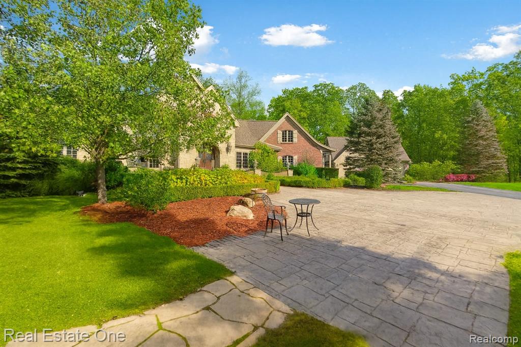 Private Lakefront Luxury on 14 Acres | Resort-Style Living with Every Amenity: Discover luxury living reimagined on this breathtaking 14-acre Waterfront Estate. An unmatched blend of elegance, privacy, and resort-style amenities. Tucked behind a gated drive and surrounded by nature on your own Cul-de-sac, this custom brick-and-stone Country French residence offers more than 7,000 square feet of refined comfort, crafted with the closest attention to detail. Inside, every space is designed to elevate daily living. A chef-inspired kitchen anchors the main level with granite countertops, Brazilian cherry floors, a wet bar, 3 Thermador ovens, and a 6-burner cooktop. The main-floor primary suite is a tranquil retreat, featuring heated flooring, a hydro jet tub, and a custom walk-in closet. A vaulted two-story hearth room with a dual-sided fireplace flows into a four-season sunroom where heated floors meet panoramic lake views. Remote workers will love the dedicated office with its own private entrance and fireplace. The finished walkout lower level transforms into an entertainer’s dream—complete with a full bar, theater room, rec space, cedar sauna, and 1.5 baths, plus a future-ready 6th nonconforming bedroom. Step outside to your personal resort: a heated saltwater pool and spa with a cabana, a lakeside gazebo warmed by a custom stone fireplace with electrical and bar storage, and your own private lake perfect for swimming, fishing, paddling, and quiet dawn reflections. Children and guests can escape to the storybook cedar loft playhouse—equipped with electricity, a fireplace, and even an intercom. A heated detached garage with a loft provides workshop and storage versatility, while a whole-house generator ensures comfort no matter the season. Whether you envision a multigenerational retreat, a year-round homestead, or a private getaway made for hosting, this singular estate offers space, serenity, and adventure at every turn. Waterfront and acreage!