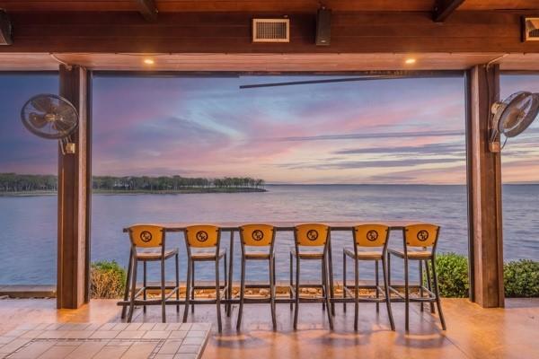 The best waterfront on the lake! TWO lots! Three build sites on four acres!!! Gated, treed, and no HOA with private ramp to beach to allow work on seawall or ripwrap retaining walls that are already permitted with the USACE and installed!