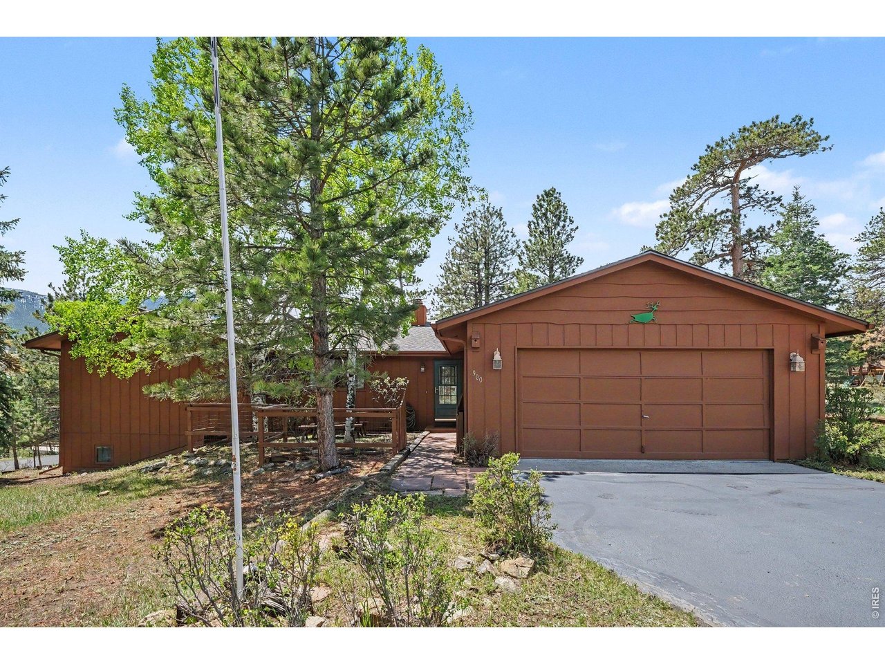**Seller is offering a $10,000 concession with an acceptable offer**, to be used toward a loan rate buy-down, closing costs, or future updates at the buyer's discretion. Located in the desirable Carriage Hills neighborhood, this 2,374 sq. ft. home offers multiple spacious living and entertaining areas, flexible-use spaces, and a great corner lot adjacent to open space. The home includes 3 bedrooms, 2.5 baths, a sunroom, and an oversized garage with abundant storage and a large workbench. The dining area features a wood-burning fireplace, and the south-facing deck provides mountain views and frequent wildlife sightings. The sunroom adds additional living space, views of the mountains and nearby Scott ponds, with excellent natural light year-round. Recent improvements in Spring 2026 include new interior paint, a new roof, and a fresh coat of asphalt on the driveway. The exterior was painted one year ago. There is forced-air heating throughout, plus zoned baseboard heating for added comfort. The home has been pre-inspected and major items have already been addressed, providing added confidence for buyers. The lower basement level with a half bath offers flexibility for a rec room, office, non-conforming bedroom, workout area, hobby space, music room, or additional storage. A separate shed provides even more room for storage or workshop use. This property offers a functional layout, generous square footage, and a highly desirable location close to shopping, restaurants, schools, Estes Park amenities, and Rocky Mountain National Park.