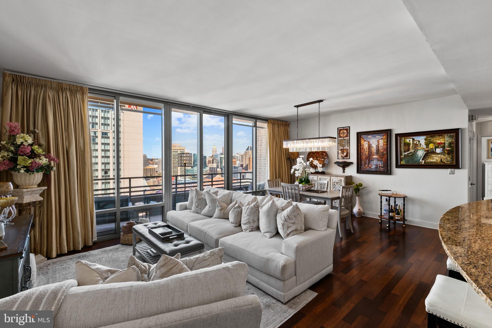 Rarely available two-bedroom, two-bath corner residence located on the 26th floor of The Vue, offering sweeping Harbor East, waterfront, and Baltimore skyline views. Floor-to-ceiling windows in the living and dining areas and primary bedroom fill the residence with natural light, while a private balcony provides an inviting outdoor setting from which to enjoy the views.The open-concept living and dining area creates a beautiful space for everyday living and entertaining, complemented by hardwood floors and motorized window treatments. The gourmet kitchen features an oversized island, abundant cabinetry, and upgraded stainless steel KitchenAid appliances. California Closets throughout the residence provide customized, thoughtfully designed storage.Surrounded by corner window walls, the spacious primary suite offers impressive views, motorized window treatments, and an oversized custom walk-in closet. The spa-inspired primary bathroom is appointed with Kohler fixtures, a Kohler deep soaking tub, separate glass-enclosed shower, and double-bowl vanity. The second bedroom and full bathroom, also featuring Kohler fixtures and a Kohler tub, provide a comfortable guest suite or flexible home-office space. A new stacked washer and dryer add everyday convenience.Two deeded garage parking spaces and a private storage unit offer exceptional conveniences in Harbor East. The storage unit (98" x 56") is located beside deeded parking space #6074 for easy access.Residents enjoy concierge service and 24/7 security throughout Harbor East, including within the building and garage. The private eighth-floor green space has no street access, creating a peaceful and secure outdoor retreat above the city. Direct elevator access connects residents to Harbor East Cinemas and the fitness center.Whole Foods Market, CVS, acclaimed restaurants, boutique shopping, luxury hotels, nightlife, and the waterfront promenade are all just steps away. Residence 2601 offers a distinctive combination of spectacular views, refined interiors, private outdoor space, security, and convenience in Baltimore’s premier waterfront neighborhood.