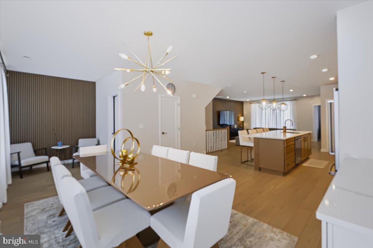 Welcome to this beautiful end-unit townhouse in the highly desirable Metro Walk Flats. With 2,672 square feet of living space, this home offers an open floor plan, extra privacy, and plenty of natural light throughout.The main living areas feature luxury vinyl plank flooring, recessed lighting, and large windows that bring in lots of sunlight and make the home feel bright and welcoming. The gourmet kitchen is a great space for both cooking and gathering, with a large island, stainless steel appliances, and a generous pantry that provides plenty of storage. The spacious dining area includes a dedicated coffee bar, adding a nice touch of convenience for your daily routine.The primary suite offers a comfortable and private retreat, featuring a beautifully designed customized en-suite bathroom and a large customized walk-in closet. The upper-level laundry makes everyday chores more convenient, while the dedicated office space on the main level gives you extra room for working from home, hobbies, or staying organized.The home also features smart home technology, an advanced surveillance system, and an indoor sprinkler system for added peace of mind. Step outside to the roof deck and enjoy beautiful views, entertain friends, or simply relax. The attached garage and driveway provide plenty of parking.The location is another great feature, with the metro station less than a mile away and the airport is less than 10 miles. Experience a lifestyle of exclusivity and comfort in this remarkable property, where every detail has been meticulously crafted for the discerning homeowner. Don't miss your chance to make this dream home your reality!