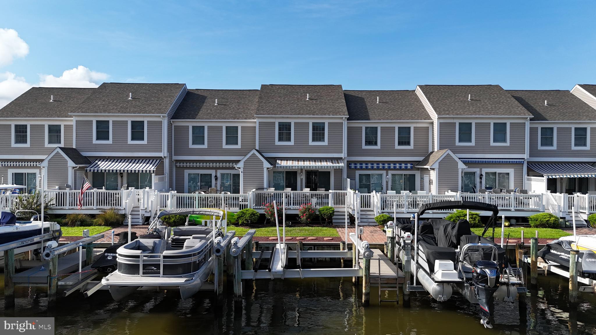 Waterfront living at its finest in North Ocean City! This beautifully maintained townhouse showcases stunning canal and bay views, complete with a deeded boat slip and lift just steps from the expansive, south-facing deck—perfect for enjoying coastal breezes and unforgettable sunsets.  Inside, you’ll find plantation shutters throughout, an upgraded kitchen with stainless steel appliances and granite countertops, and new carpeting on the second level. The open-concept layout offers both comfort and style, ideal for everyday living or entertaining.  Conveniently located just minutes from popular dining, shopping, and Northside Park, and only a short drive or easy bike ride to both Ocean City and Fenwick beaches. Whether you're looking for a full-time residence or a vacation retreat, this home checks every box—and with no city taxes, it’s an even greater value.  Additional highlights include first-come, first-served extra parking and direct water access—making it easy to boat to local restaurants, enjoy fishing or crabbing, attend waterfront events, or simply cruise the bay by boat, jet ski, or kayak. Prefer the sand? The beach is just a 5-minute drive or a scenic 25-minute walk away.  Don’t miss this rare opportunity to experience the best of waterfront living—schedule your private tour today!