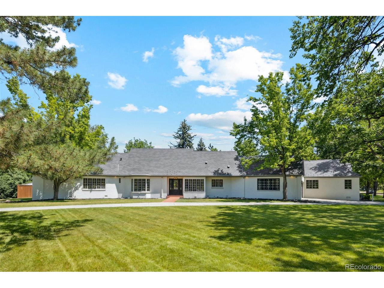 Recently appraised for $3,075,000. Located in the desirable Cherry Hills Heights neighborhood, situated on a corner lot w/ approx .79 acres. A graceful circular driveway along with majestic trees welcomes you to this thoughtfully renovated property featuring 2 homes w/ approx 6,148 sqft. The main house offers 5 bedrooms & 4.5 bathrooms, and the ADU offers 3 bedrooms, 2 bathrooms & a separate entrance, perfect as a granny flat/rental. Modern amenities plus touches of luxury have been added throughout the main house such as wide plank french oak engineered wood floors, designer paint, a gourmet kitchen showcasing opal white satin marble slab counters & waterfall ends, marble tile backsplash, brand new appliances: 8-burner double convection oven gas range, 60" french door ref/freezer, matching dishwasher, built-in microwave drawer, built-in cabinetry w/ custom crimped hand woven brass grille, coffee/wine bar w/ a dual zone wine cooler, fireplace w/ a stunning surround, primary suite with an elegant spa-like ensuite (heated marble floors, soaking tub w/ marble backsplash, shower w/ marble surround & floors, dual vanities w/ marble counters), generously sized loft with a bedroom that has a seating area & an ensuite plus a bonus room (use it as a play room/yoga room), and a brick patio in the expansive backyard. The ADU boasts a modern living/dining combo, volume ceilings, well equipped kitchen w/ stainless steel appliances & granite countertops, and french doors that open to the garden. The property is located in the Cherry Creek School District. Property sold as-is where-is.