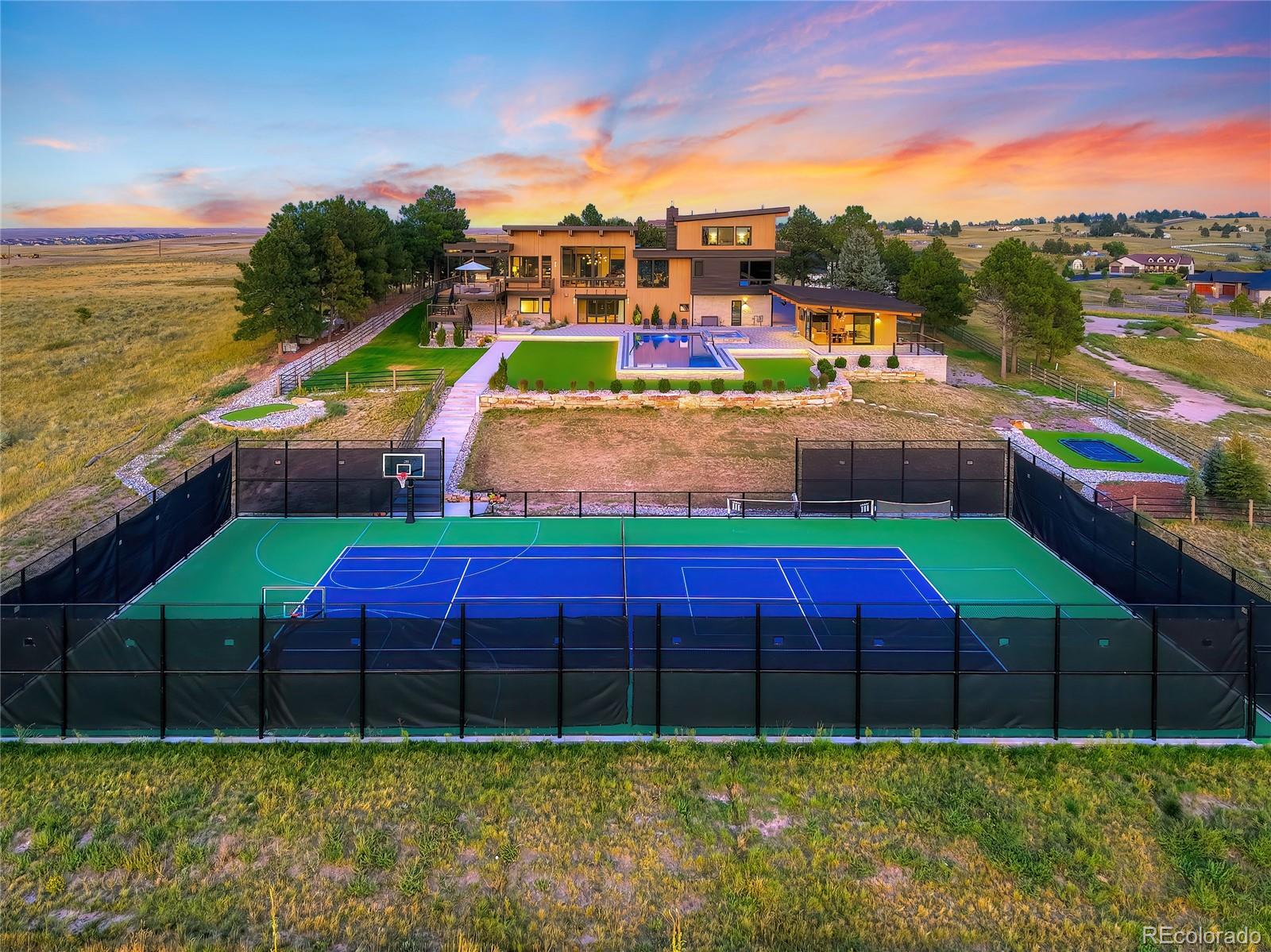 Welcome to Summit Haus. A true family resort style Estate on TWO lots totaling almost 5 acres with HUGE Denver Skyline Views. As soon as your private gate opens you will be taken away by the private oasis feel and amenity packed compound including FULL size 20 Meter Swimming Pool, Full size Basketball Court, Full size Tennis Court, In ground Trampoline, Pool house and separate LOT that is fully sodded and ready to use as your own private football field or build another Home. Separate lot is shovel ready and can break ground immediately or in the future! 10811 Shadow Pines is something Parker has never seen till now. BRAND New Construction in 2023, an architectural masterpiece designed for entertaining and family gatherings. Truly TOP of the hill sitting on two of the highest elevated lots in ALL of Douglas County with huge views of the Foothills and Downtown Denver. Walk into the front door and be immediately drawn to the floor to ceiling windows facing west looking right at the beautiful mountains and 100 acres of OPEN SPACE. A once in a lifetime opportunity that can NOT be duplicated, this custom Parker Home perfectly positioned just 5 minutes from Southlands Shopping Center, 24 Minutes to Denver International Airport, and only 19 minutes to the Centennial Private Airport gives you the best of everything! A thoughtful floor plan with 6 bedrooms plus a separate pool house, guest house, office or gym gives you a flexible 7 bedroom plus 7 bathroom home. You must come walk the grounds and see the attention to detail to really appreciate this luxury estate. This is the best of Parker, your dream home awaits now. Schedule your private tour today to see this exclusive rare estate. A MUST SEE! The best views in Parker. Downtown Denver Skyline from your living room is a must see.
