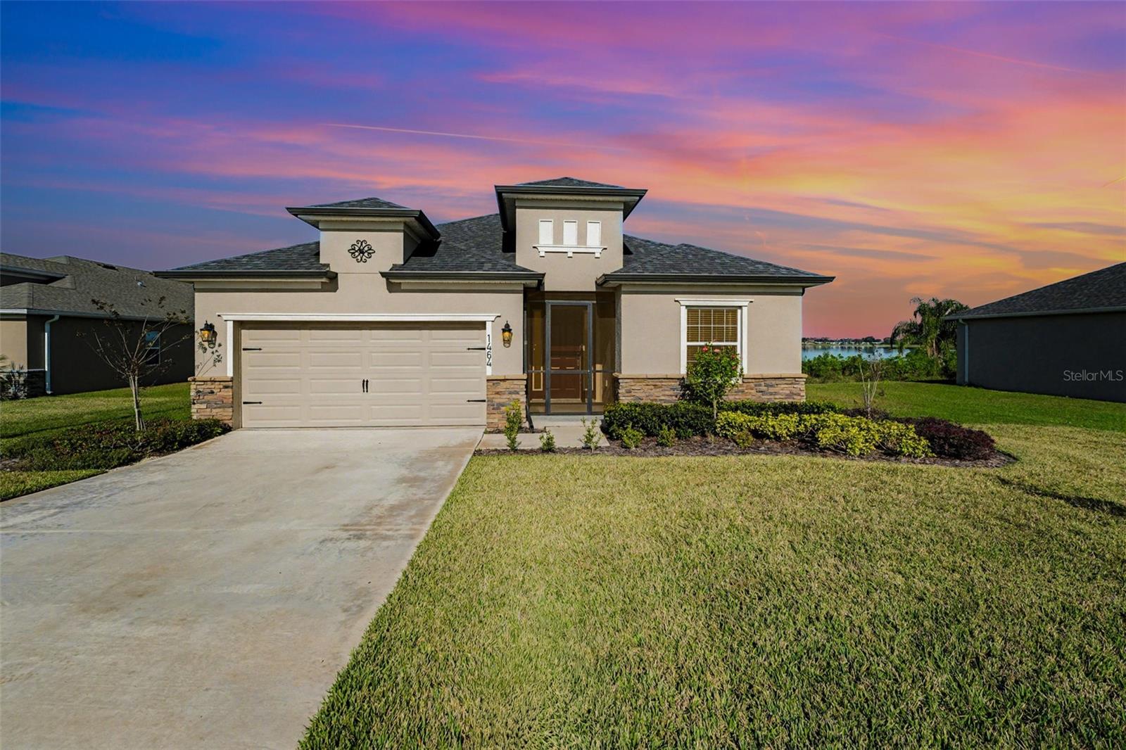Set on a rare quarter-acre lake-view homesite, this newly built 2024 residence by Clayton Properties Group offers the advantage of modern construction without the wait, paired with a serene Lake Alfred setting. Designed for both comfort and functionality, this single-story layout spans 1,938 square feet and centers around an open-concept living space that seamlessly connects the kitchen, dining area, and family room. The kitchen is thoughtfully appointed with Silestone countertops, stainless steel appliances, a pantry, and a counter-height island that anchors the home's social core. The primary suite is privately positioned and features a walk-in closet and an en-suite bath with dual vanities, a tiled shower, and a separate water closet. Two additional bedrooms share a pass-through bathroom, while a dedicated office provides flexibility for remote work or additional living space. Vinyl Plank flooring extends throughout the entire home, enhancing durability, continuity, and ease of maintenance. A covered patio extends the living space outdoors, offering peaceful lake views and a natural backdrop. Additional features include a screened front entry, a two-car garage, custom-fit window blinds, architectural shingles, and upgraded electric car outlet. Ring Doorbell Camera conveys with the property. Located within an HOA community and conveniently to local lakes, everyday amenities, and regional access to Winter Haven, Orlando, and Tampa, this move-in-ready home presents an exceptionalopportunity for modern Central Florida living.