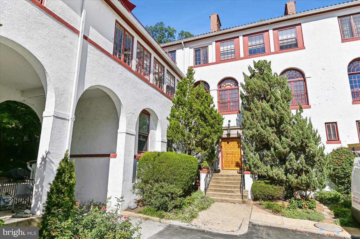 If you have ever dreamed of living in a small Mediterranean village with views of pristine red terra-cotta roofs, authentic white stucco facades with crimson trim, and beautiful archways, that dream can now be your reality. Introducing the Gardens of Guilford. Constructed in 1922 by the talented architect Clyde N. Friz, this notable enclave, originally known as “Campagnia,” is one of Baltimore’s best-kept secrets.The building entrances impress with heavy handcrafted doors that lead to terra cotta hallways and wide stairways lined with beautiful wrought-iron bannisters. As you enter this spacious unit, a generous foyer welcomes you, featuring closets on your left and a huge south-facing sunroom that is currently used as an artist’s dream studio filled with copious amounts of natural light. This room offers endless possibilities to suit anyone's needs.Next, you're greeted by a wide open space adorned with beautiful hardwood flooring that is consistent throughout the unit. The living room, complete with a wood-burning fireplace, is on your right, while the dining room is on the left. Additionally, a custom standing bar with quartz countertop anchors this end of the room, making it perfect for entertaining.The large and recently remodeled kitchen is just around the corner, boasting stylish custom flooring and cabinetry, quartz countertops, and stainless steel appliances. The unit also features a primary bedroom with an en-suite bathroom, as well as two additional bedrooms and a hall bathroom.For your convenience, additional storage is available in the building’s lower level, and ample unassigned parking is provided on the property. Enjoy urban living with a variety of restaurants, coffee shops, museums, and shopping all within easy walking distance. Don’t miss the opportunity to make this stunning unit in the Gardens of Guilford your new home.