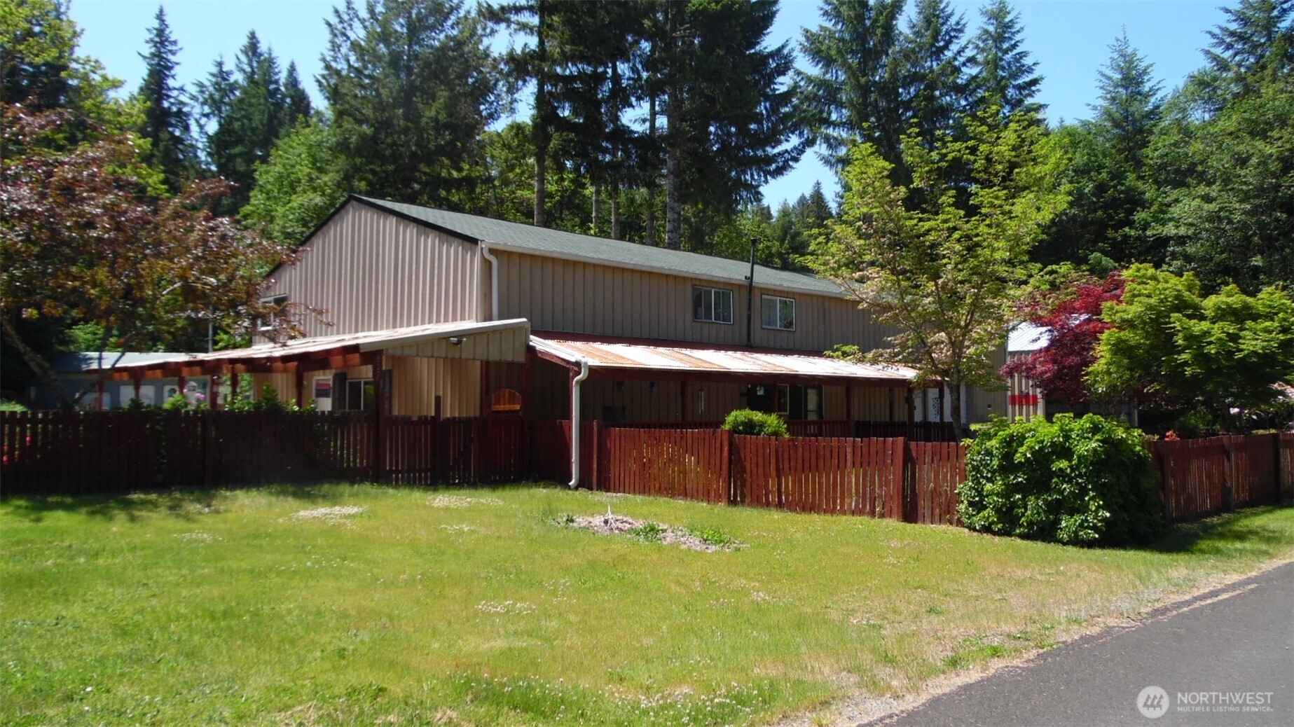 One of a kind 4032 square foot home located near the Gifford Pinchot wilderness. Two lots totaling 1.01 acre with a 3 car carport and a two car attached garage with a huge storage area above. The kitchen has loads of cabinet space, two full sinks, and an island with a breakfast bar. Don't forget to check out the lighting in there.  A butler pantry, utility room and full bath complete the main floor. 3 bedrooms and a beautiful primary suite boasts a sitting area. Two covered porches, fruit trees, a garden area and gorgeous flowers in the front and side yards. The second lot is set up for an RV with power, water, etc. Property is fenced and cross fenced. This would make a fabulous venue, meeting place, or residence. Bring your imagination.