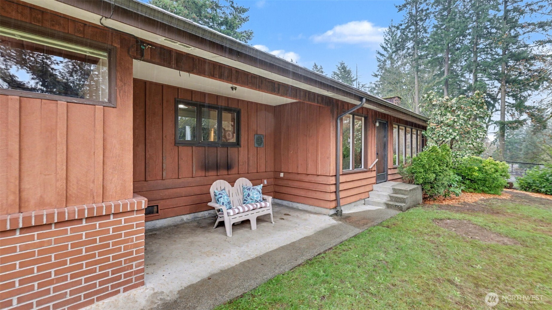 Steps from the shores of Lake Meridian, this custom one-level home on over 1/3 of an acre has so much to discover. Stately brick and rough-cut cedar siding provide enduring exterior finishes, while the spacious bonus room or primary suite with wood burning fireplace, stone hearth, exposed cedar beams and extra-tall tongue and groove ceilings has the lakeside cabin vibes you dream of. Oversized picture windows in the living and dining room look out to tranquil lake views. All three bedrooms have garden views with a full bath in the hall plus a 3/4 bath off of the bonus room which has a sliding door exiting to the backyard patio running the full length of the home amongst a lovely treed setting. Perched up and away from the street with a long driveway allowing for ample parking leading up to the extra large two-car detached garage. Trophy location features Lake Meridian park and the Soos Creek trail right out your doorstep, shopping and restaurants only a couple minutes away, plus easy access to commuter routes.