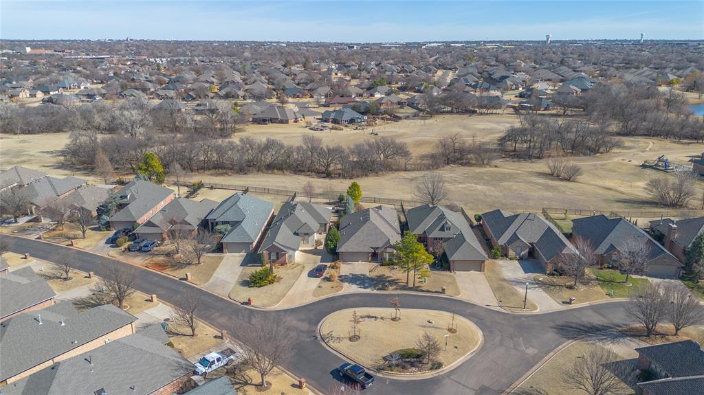 Welcome to Traditions, a highly sought-after gated community in Edmond! This well-maintained, move-in-ready home backs to a peaceful greenbelt with fabulous views and showcases true pride of ownership.The home features 3 bedrooms, 2 full baths, and a 2-car garage, along with a sprinkler system, security system, and a large storm shelter. The spacious kitchen offers granite countertops, updated stainless steel appliances, new sink and faucet, pantry, large breakfast bar, and abundant cabinet space. The dining area overlooks the backyard and comfortably accommodates a large table—perfect for entertaining.The family room boasts bamboo wood floors, crown molding, ceiling fan, and a cozy gas-log fireplace. The extra-large primary suite includes a sitting area, built-in bookcases, bamboo wood flooring, and ceiling fan. The primary bath features a skylight, granite vanity with dual sinks, walk-in shower, and walk-in closet.The second bedroom is located at the front of the home and offers plantation shutters, bay window, ceiling fan, and bamboo wood floors. The hall bath includes a granite vanity and whirlpool tub. The third bedroom also features bamboo wood floors and a ceiling fan. A utility room with storage and a window adds convenience.Recent updates include interior paint, landscaping, A/C, and a flagstone sidewalk. HOA dues cover gated entry, front and back lawn mowing, and greenbelt maintenance. Located within Edmond Schools while offering OKC utilities.This is truly a must-see home—pride in ownership shines throughout!