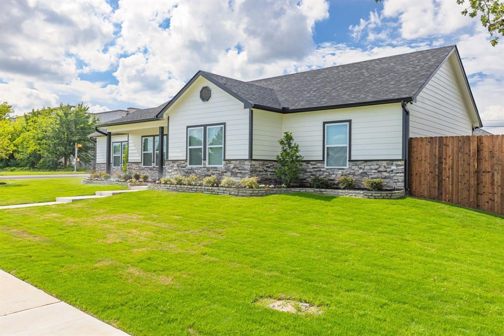 NEW construction just built in 2025! You can watch your children walk to school from this corner lot home with crosswalk and newly installed sidewalks. This handsome 3bed, 2bath home comes with elegant upgrades. In the u-shaped kitchen, you'll find granite countertops, farm sink, subway tile backsplash, and shaker cabinets with plenty of countertop space and storage. Rich luxury vinyl plank floors enhance the living and dining areas, hall, and bathrooms. Ceiling fans, in the living room and in each bedroom, will help you stay cool while recessed lights brighten every room. The primary bedroom with raised ceiling includes an ensuite bathroom with granite countertops, double sink, and oversized walk-in shower with seat. Two additional guest bedrooms share a full bathroom in the hall that comes with granite countertops and bath with sleek glass doors. A two-car side entry garage provides a place to shelter your cars from the weather. Sit on the covered back patio, soaking in the backyard with its privacy wood-fencing and lush green space. Keep this property's curb appeal with a fully sodded grass lawn, built-in automatic sprinklers, landscaping, and porch. Easy interstate access makes it great for commuters. Buyers looking for peace of mind will appreciate this new construction!