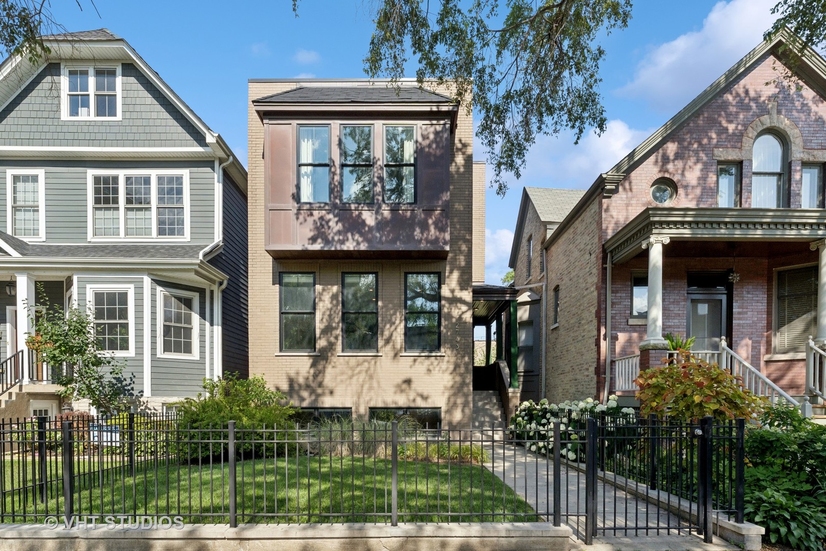 This stunning 5-bedroom, 3.5-bathroom brick home showcases exceptional craftsmanship and luxurious finishes throughout, offering an ideal layout on one of Logan Square's best blocks. Thoughtful construction features high ceilings, designer lighting, and custom window treatments. The set-back entry leads into a spacious, wide front living room with views of the beautiful front yard, creating a warm and inviting atmosphere. The chef's kitchen is a standout with custom cabinetry, commercial-grade appliances, quartz countertops, a pantry, and ample space for cooking and entertaining. It seamlessly flows into the beautifully appointed family room with a gas fireplace, built-ins, and access to three outdoor spaces, including a deck perfect for grilling. On the second level, you'll find three generously sized bedrooms, two bathrooms, and a convenient laundry closet. The spacious primary suite offers a walk-in closet and a luxurious en-suite bathroom with dual vanities, a large marble shower, a separate soaking tub, and heated marble floors. The lower level features radiant heated tile floors, a massive family room with a wet bar, two additional bedrooms, a full bathroom, and a mudroom with a second laundry room. Abundant outdoor spaces include a front yard, a deck off the family room, a large patio with turf in the backyard, and a fabulous garage rooftop deck with a pergola and custom shades. The garage is equipped with an EV charger and has a hook-up for outdoor speakers and a TV, making it the perfect space for outdoor entertainment. Additional features include permanent baby gates installed for safety, as well as a stair runner for added comfort and style. Located just steps from Logan Boulevard, the Farmer's Market, Starbucks, and some of the finest restaurants Logan Square has to offer, this home is the epitome of comfort and convenience.