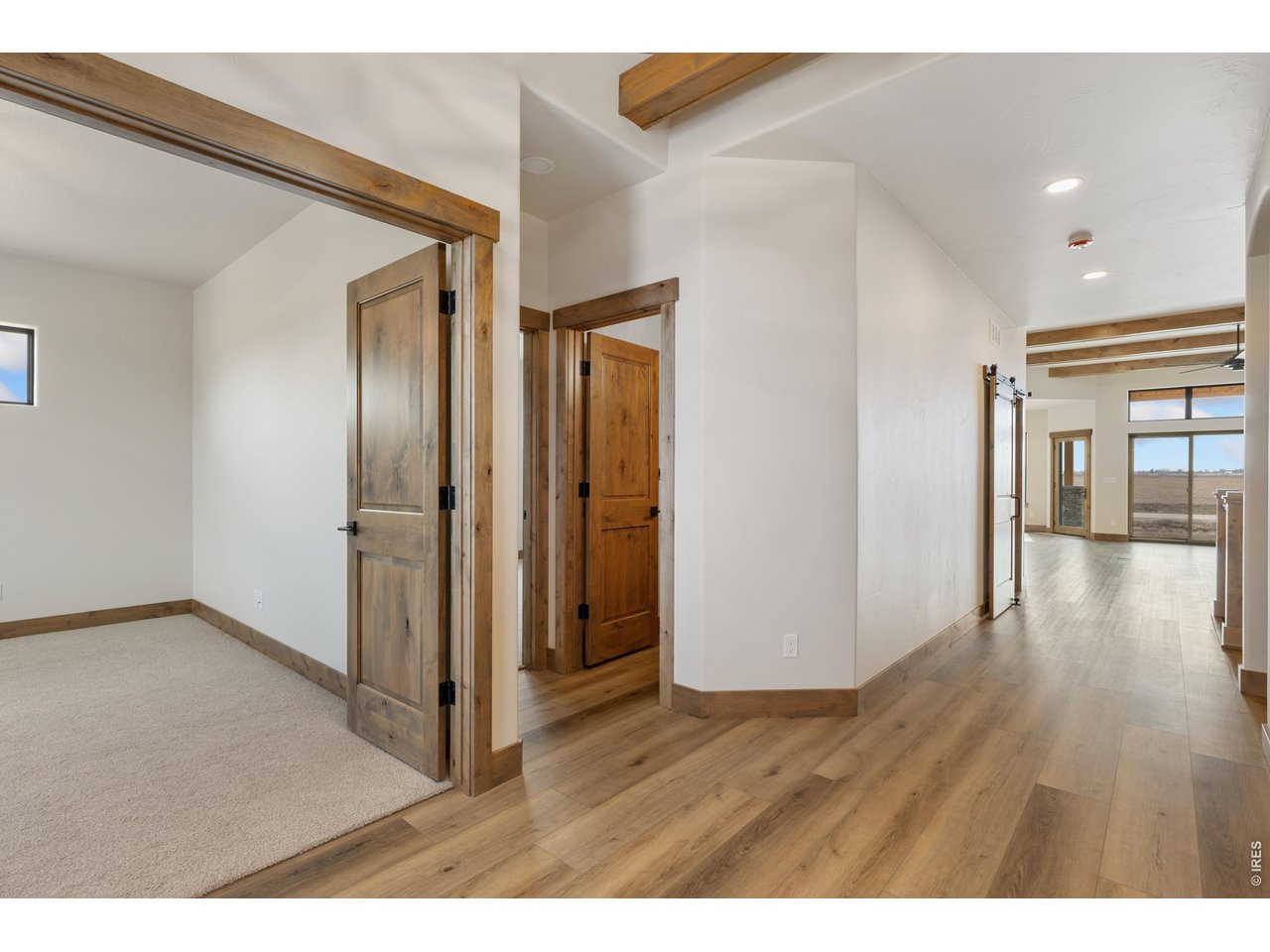 Experience exceptional craftsmanship in this like-new custom home on nearly an acre with breathtaking panoramic views, professionally designed low-maintenance landscaping, and a quiet cul-de-sac location. Plus---NO METRO and ability to add an ADU! This home is built by one of Northern Colorado's premier custom builders, Custom On Site Builders, this home showcases outstanding quality, thoughtful design, and luxury finishes throughout. The covered front porch welcomes you into an open floor plan with soaring ceilings, wood beams, hand-troweled walls, knotty alder cabinetry, extensive real wood trim, and a stunning wood-burning fireplace. The chef's kitchen features an oversized island with abundant storage, hidden walk-in pantry with space for a second refrigerator, under-cabinet lighting, and exceptional functionality for everyday living and entertaining.Expansive 12-foot glass doors open to the oversized covered patio, creating seamless indoor-outdoor living while capturing the incredible mountain views and peaceful surroundings.The luxurious primary suite offers a spa-inspired walk-in shower, dual vanities, and a spacious walk-in closet. The laundry room is beautifully appointed with floor-to-ceiling cabinetry, utility sink, generous counter space, and abundant storage.The partially finished basement is ideal for entertaining or multi-generational living with an impressive wet bar featuring a refrigerator, microwave, extensive counter space, and ready for a future fireplace. Additional features include dual-zone heating and cooling, tankless water heater, built-in storage throughout, and thoughtfully placed electrical outlets.Fall in love with the oversized 3+ car garage with dedicated workshop and storage space and pre- wired for an EV charger.Every detail reflects exceptional craftsmanship and pride of ownership, offering a rare opportunity to own a truly custom home in one of Northern Colorado's most desirable settings. Home is occupied