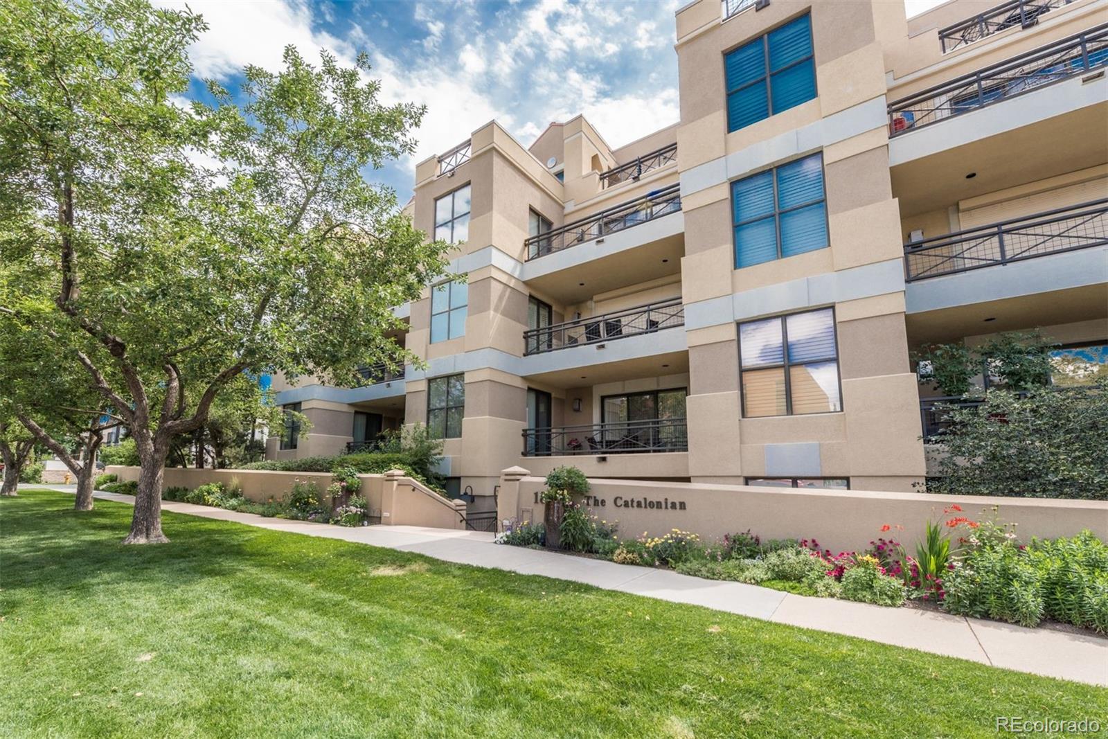 Experience elevated living in this exceptional 2-story penthouse in Cherry Creek North. This exclusive residence offers breathtaking views of the Denver skyline, Front Range, and Cherry Creek area from multiple private west-facing decks. A dramatic two-story foyer with grand lighting sets the tone for the sophisticated living spaces beyond.The spacious primary suite is a private retreat with its own balcony, walk-in closet, and a spa-like five-piece bath featuring a jetted tub, dual shower heads, and a bench. The secondary suite offers a custom bath with steam shower, ideal for guests or use as a den. A full laundry room and ample storage complete the main level.A custom industrial staircase leads to the stunning upper-level living area, where vaulted ceilings, expansive windows, and a gas fireplace create an inviting space for relaxing or entertaining. The open-concept design connects the dining area and gourmet kitchen, complete with Bosch and KitchenAid appliances and rich cherry cabinetry.Private outdoor living continues upstairs with a spacious west-facing balcony perfect for sunsets. Modern touches include updated wood floors, oak stairs and great room flooring, four Capiz chandeliers, a wall mural, indoor/outdoor speakers, and a security system.Two deeded underground parking spaces plus ample guest parking add convenience. Located steps from Cherry Creek Mall, fine dining, boutique shopping, gyms, and the Cherry Creek Trail, this penthouse delivers luxury, privacy, and a premier lifestyle.