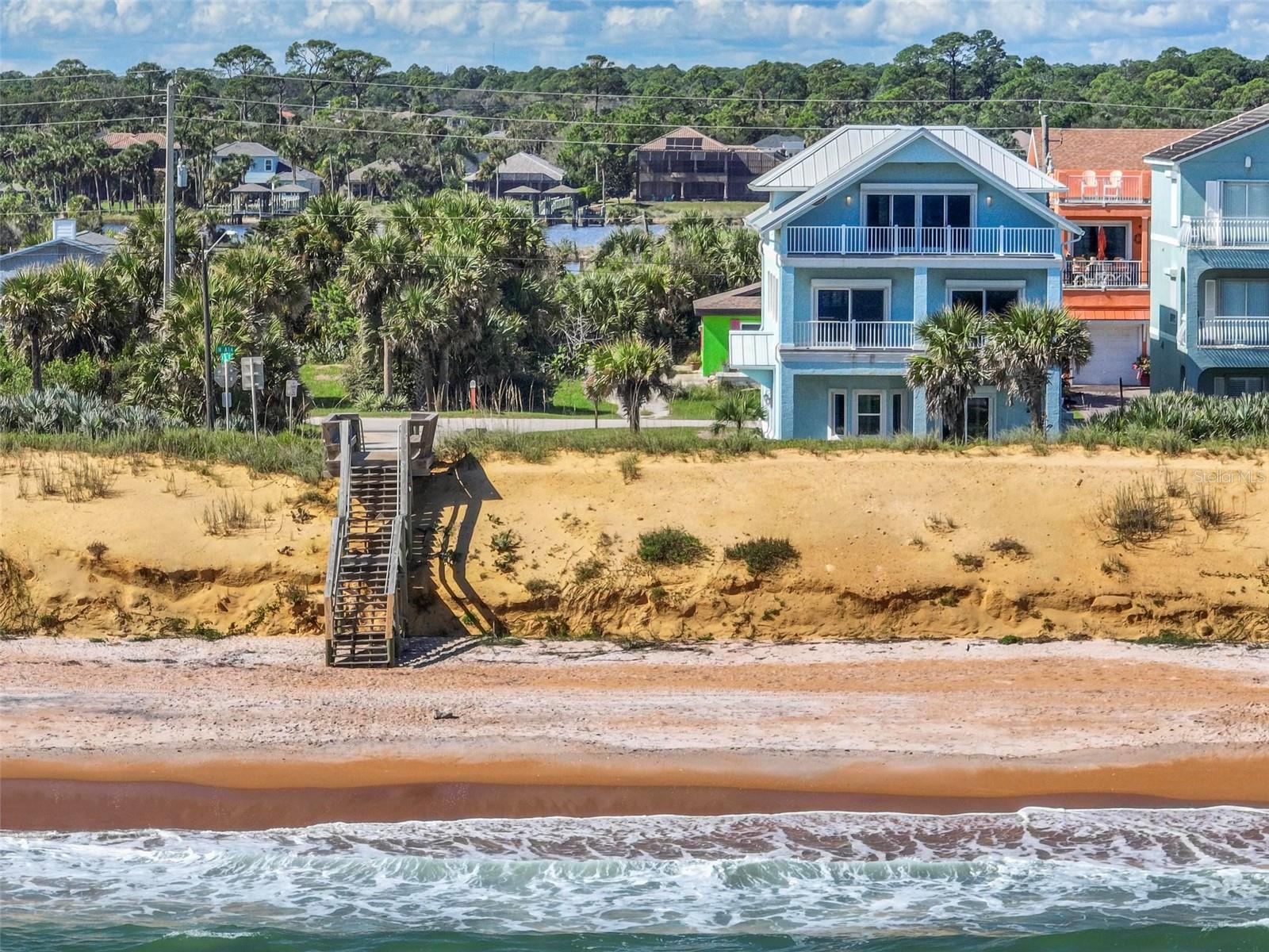 LOCATION, LOCATION, LOCATION! Coastal living in Flagler Beach! Discover the possibilities this spacious 3 story beauty offers at 3,736 heated sq ft of living space, it will please & provide the room to create your ideal coastal retreat. This home provides room the gather, entertain & relax. The living and dining area showcase endless ocean views, creating an inviting backdrop for everyday living and special occasions. The custom kitchen has a gas range, all appliances needed, beautiful granite, loads of cabinets, pantry and island for plenty of prep space. Hardwoods flank the second floor & the huge 24x28 entertainment room offers exceptional space for hosting guests, game night or movie nights, it's the ultimate recreation area with a wet bar. A choice of primary suites await on the top level. Both have views, one has an expansive ocean view w/dbl sliding doors to the covered balcony, the back bedroom has lots of windows to see amazing sunsets, Silver Lake and the intracoastal. Both have lots of closets and connect to a large bathroom complete with a water closet, dbl sinks walk-in shower & clawfoot tub. The first level is fully tiled, has a bedroom with dbl closets and a sleeping loft, & 2 additional rooms to house guests as well. This home features a large staircase but there is plenty room for a future elevator if desired. Metal roof 2020, gas hot water 2021, HVAC 2022. Located along the iconic A1A corridor, enjoy the relaxed beach-town lifestyle that makes Flagler Beach so special. Whether you're envisioning a full-time residence or vacation getaway, this property has the potential. Enjoy the unique charm of coastal living, a beach, farmer's market, local dining & coffee shops, a boat launch & you won't have to cross the bridge!