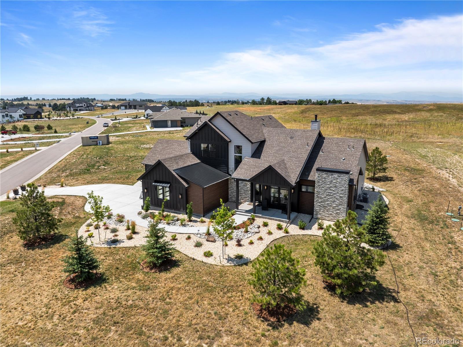 *MODEL HOME FOR SALE* Offered at $1,950,000 and sold fully furnished, the stunning Serenity model home showcases modern farmhouse architecture with a refined contemporary twist. This beautifully designed residence features an expansive open-concept layout filled with natural light, highlighted by a dramatic floor to ceiling window wall and soaring 12' ceilings accented with custom wood beams. The gourmet kitchen is a true centerpiece, blending oak and white Yorktown cabinetry with an oversized island, brushed gold fixtures, and an additional prep kitchen complete with a sink and walk-in pantry for optimal storage and functionality. The spacious great room centers around a striking fireplace with tile surround, creating a warm yet sophisticated atmosphere. Designed for ease of living, the home features a luxurious main-floor primary suite with a recessed ceiling detail, along with a main-floor study for added flexibility. Thoughtful design continues upstairs with an open loft overlooking the entryway, while high-end finishes throughout include hardwood stairs, black metal horizontal railings, and hardwood flooring in the upper bonus room and basement. Perfect for both everyday living and entertaining, the home also offers a wet bar, wine room, home gym, covered BBQ deck, and a rare four-car garage—delivering a turnkey opportunity that blends comfort, style, and elevated living.  And the best part, the home sits on 1.5 acres.